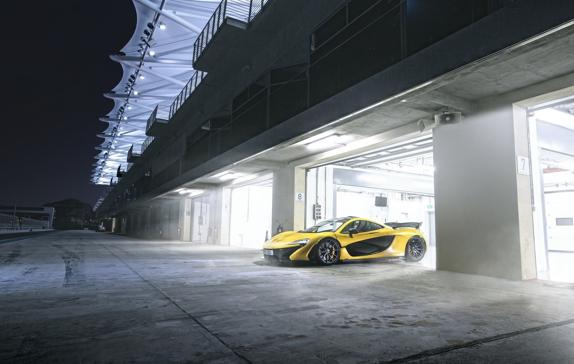 Yellow McLaren P1 parked in a garage at night HD Wallpaper