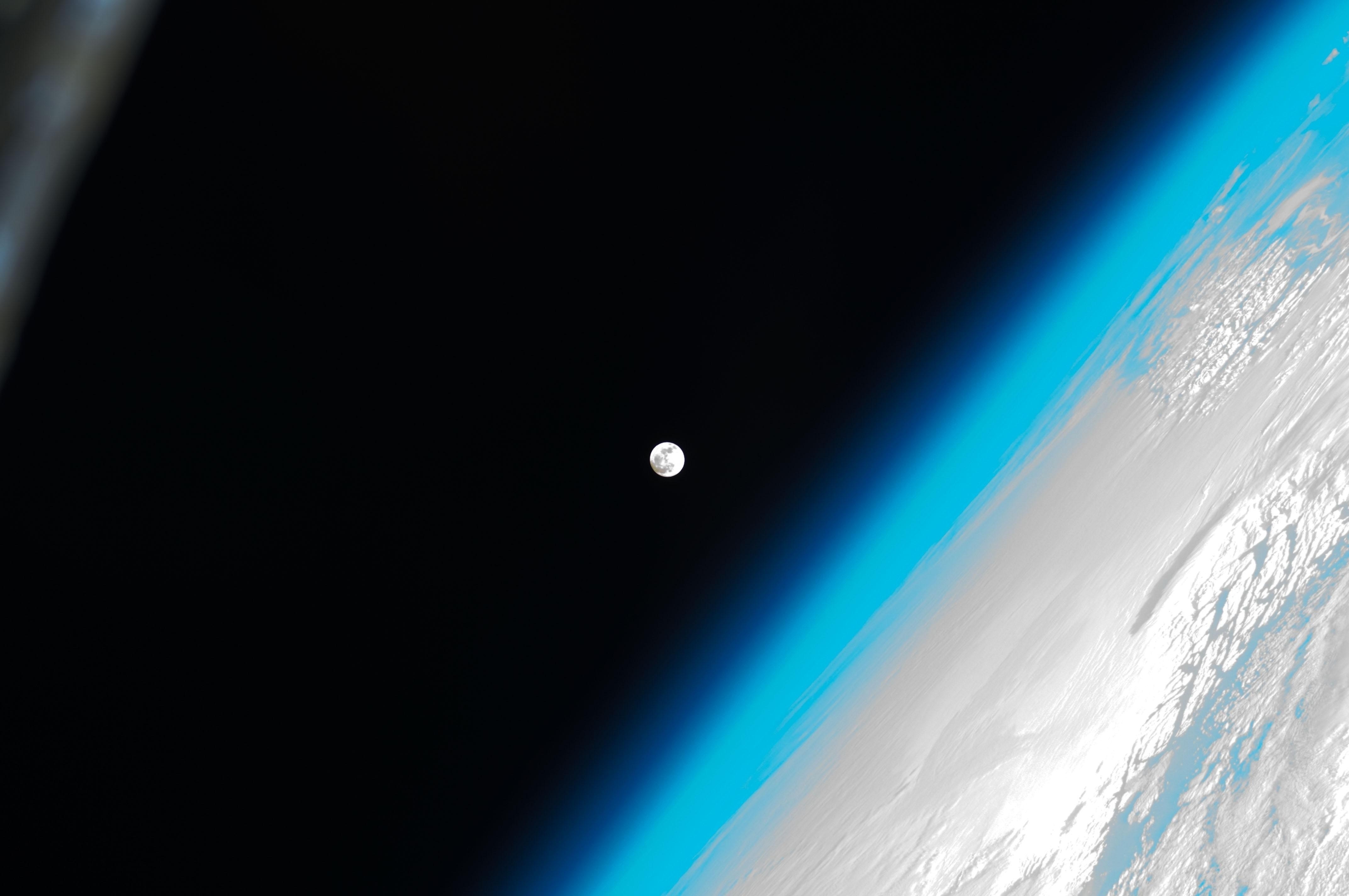 Earth's atmosphere and the Moon from space HD Wallpaper