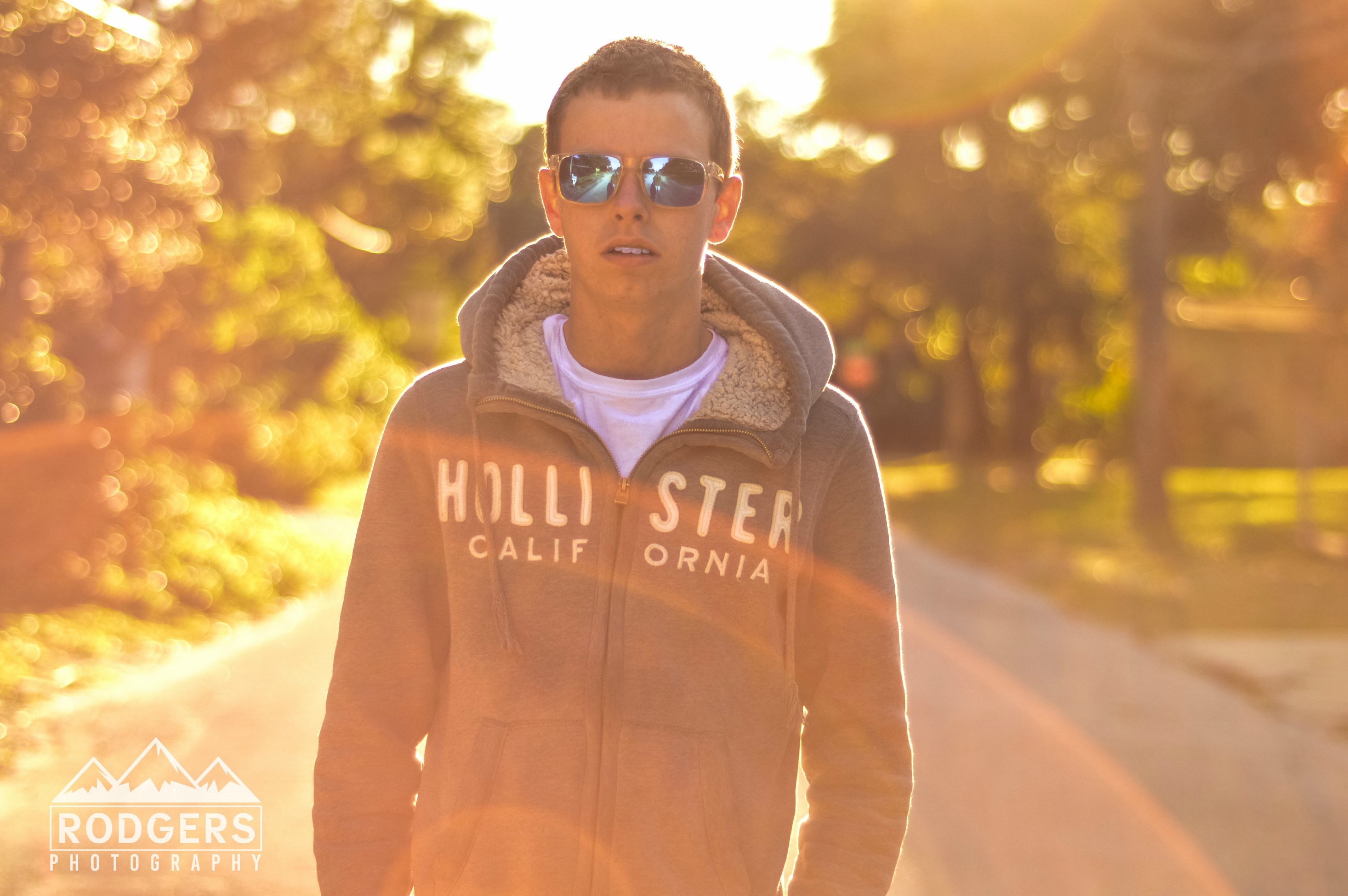 Man wearing Hollister hoodie and sunglasses outdoors HD Wallpaper
