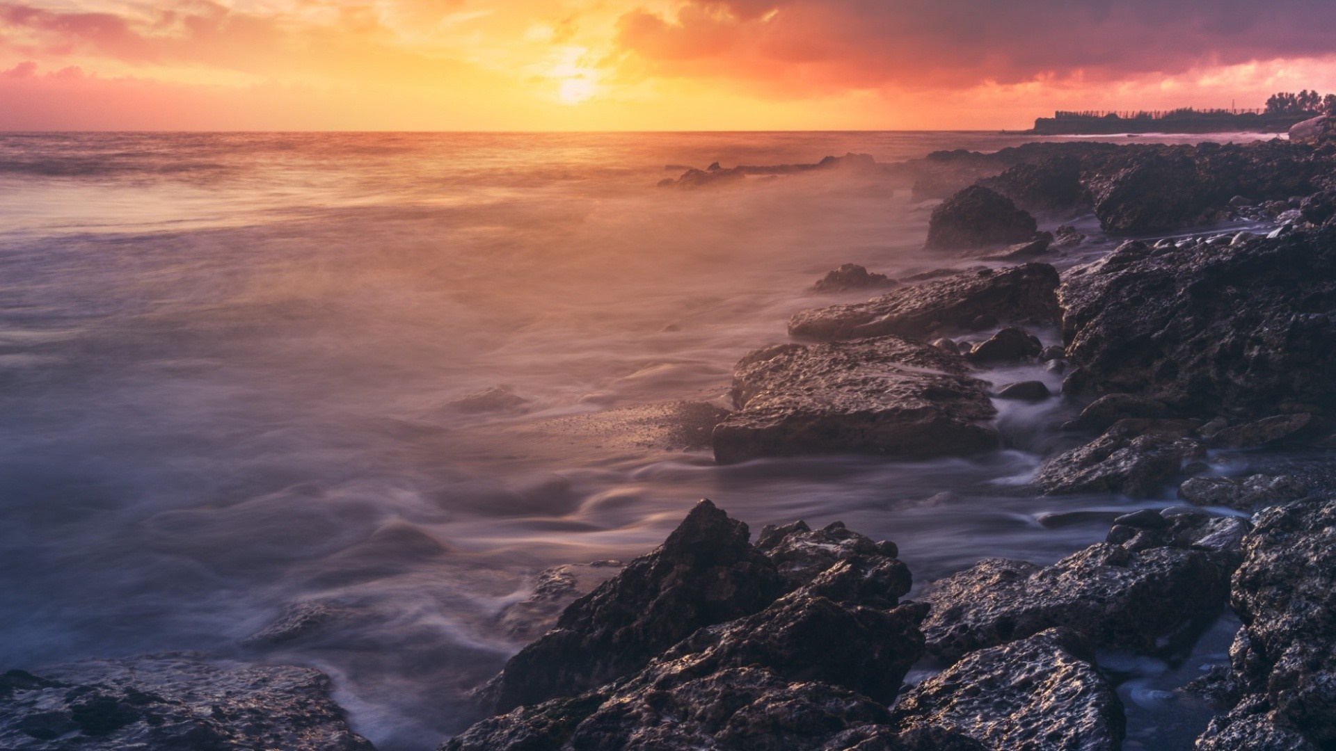 Rocky coast at sunset with ocean waves HD Wallpaper