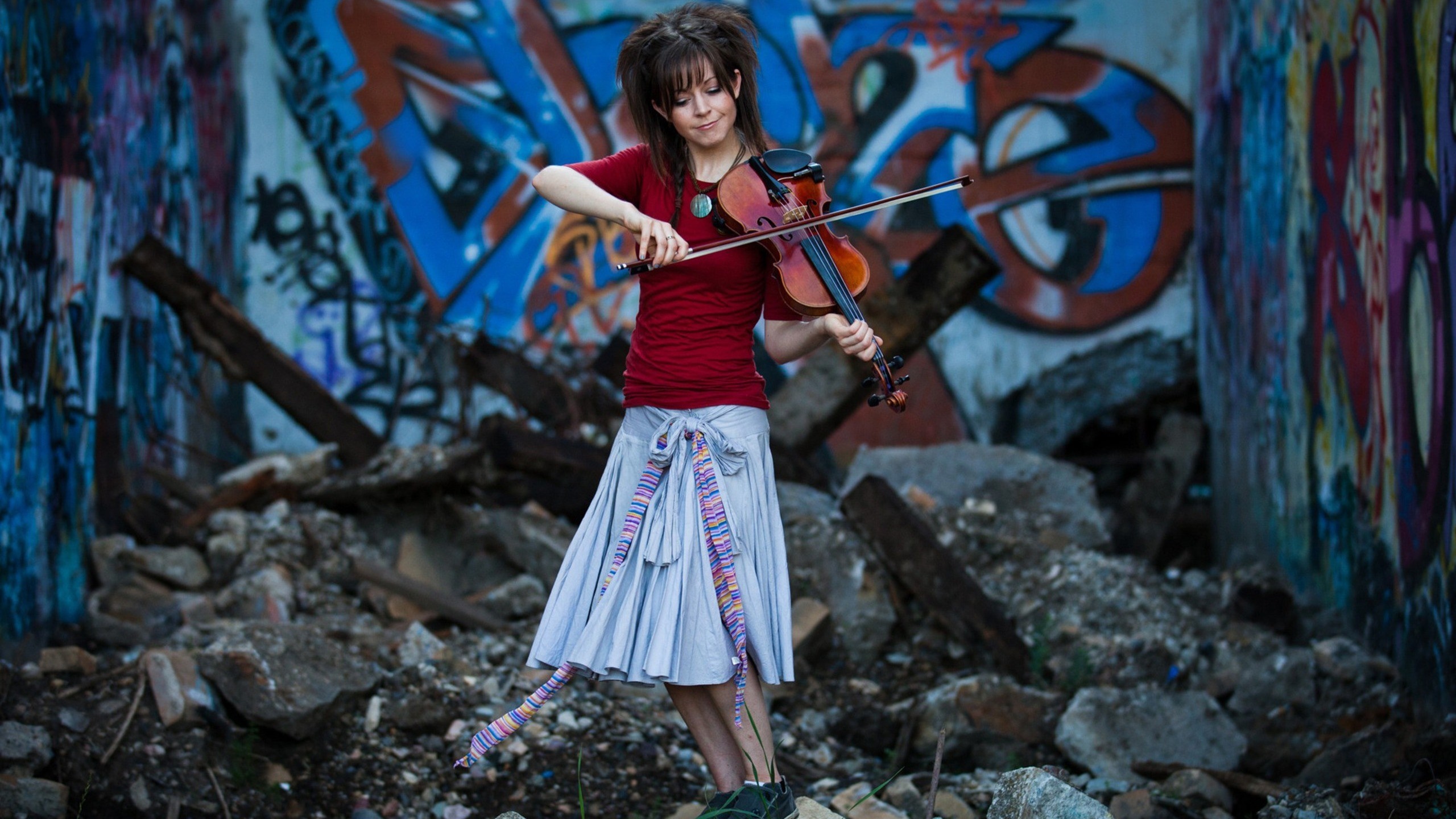 Woman playing violin in front of graffiti wall HD Wallpaper