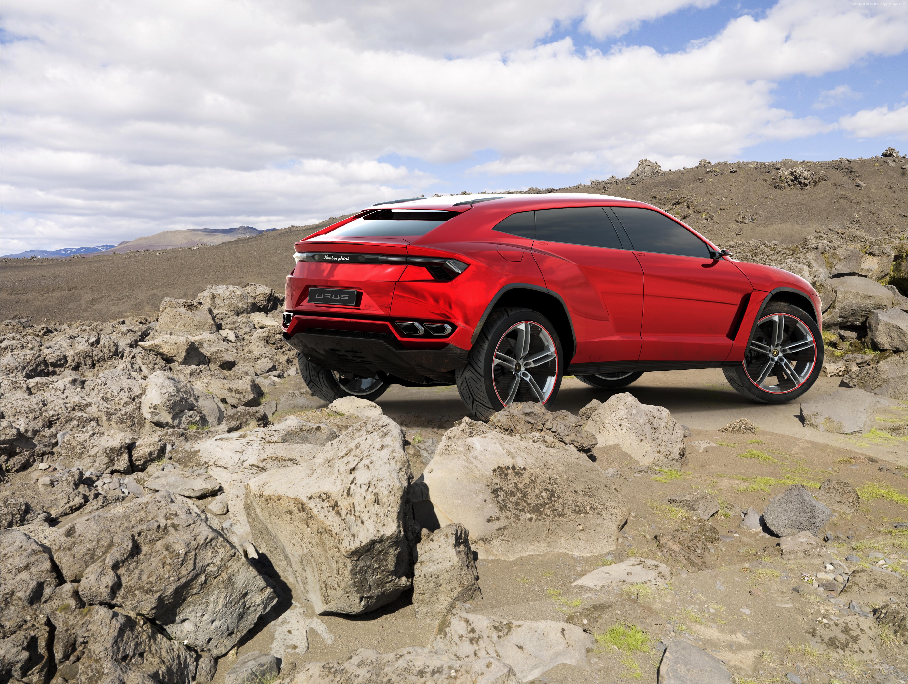 Red Lamborghini Urus concept SUV on rocky terrain HD Wallpaper