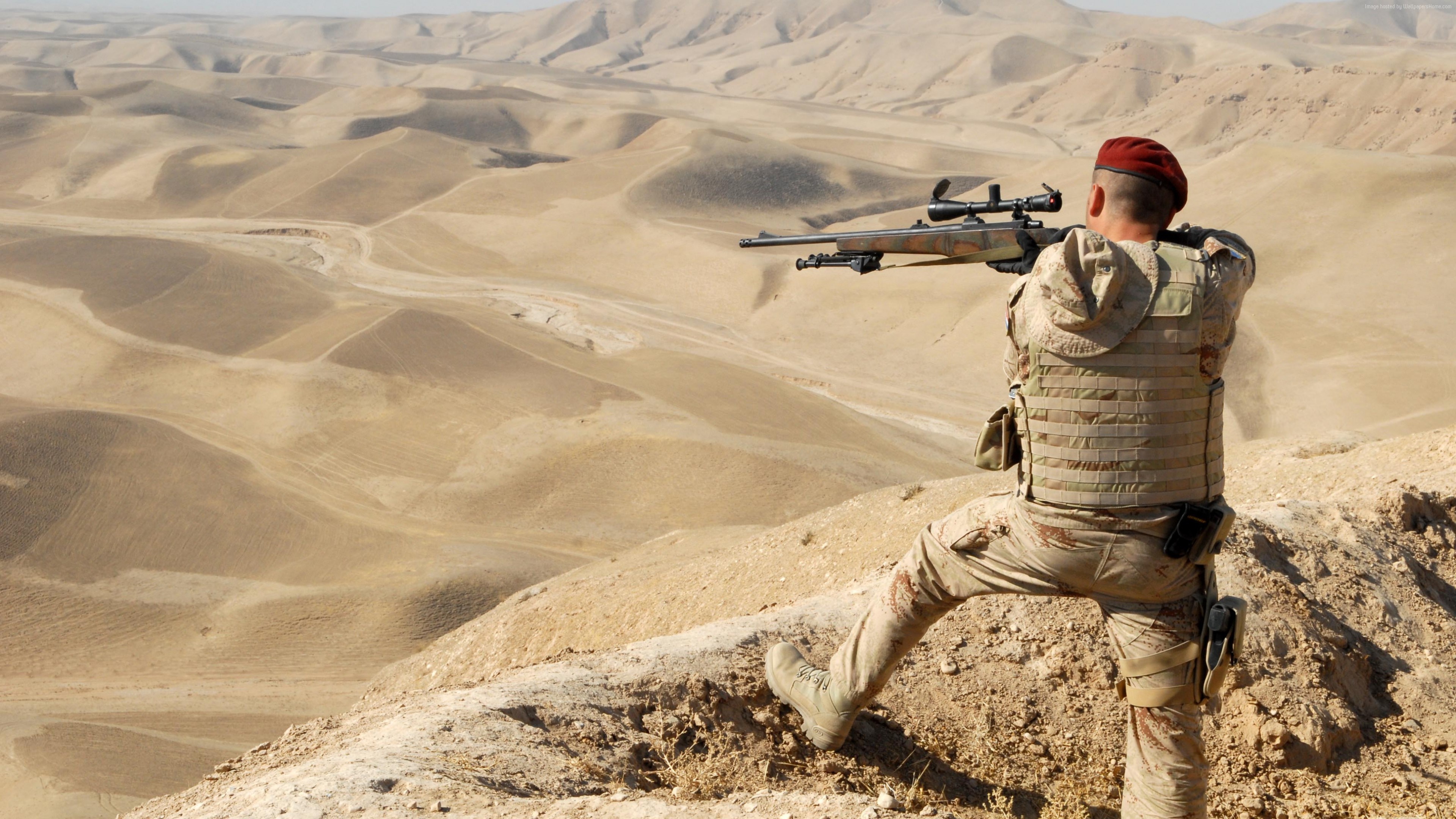 Soldier with sniper rifle in desert landscape HD Wallpaper