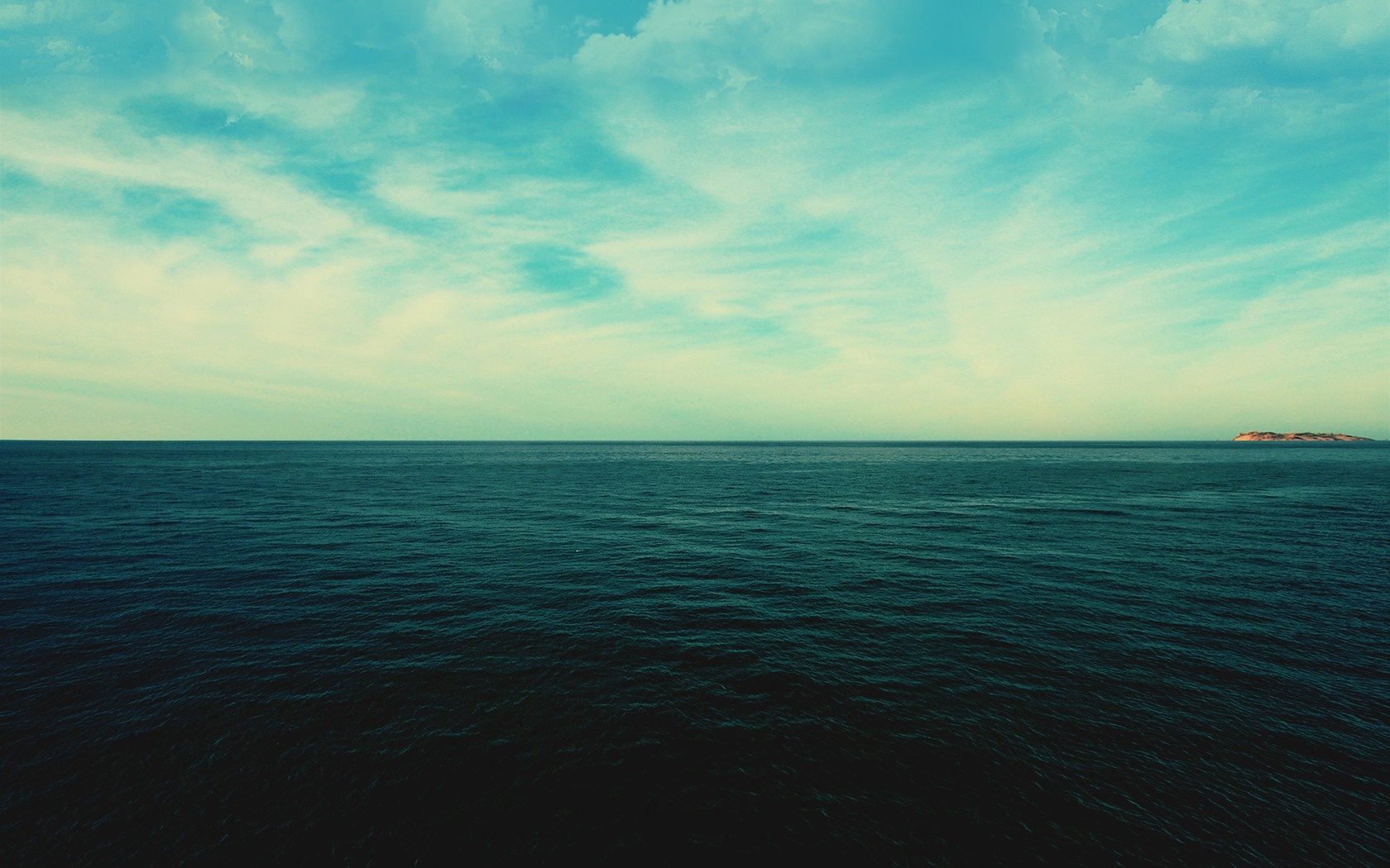 Ocean horizon with clouds and distant island HD Wallpaper
