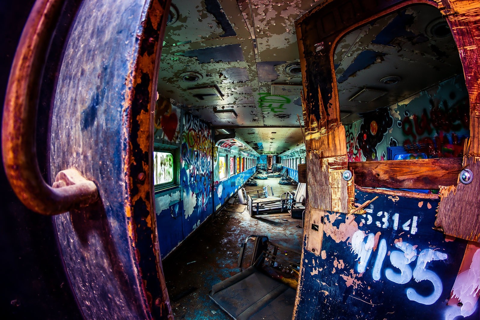 Graffiti-covered abandoned train interior HD Wallpaper