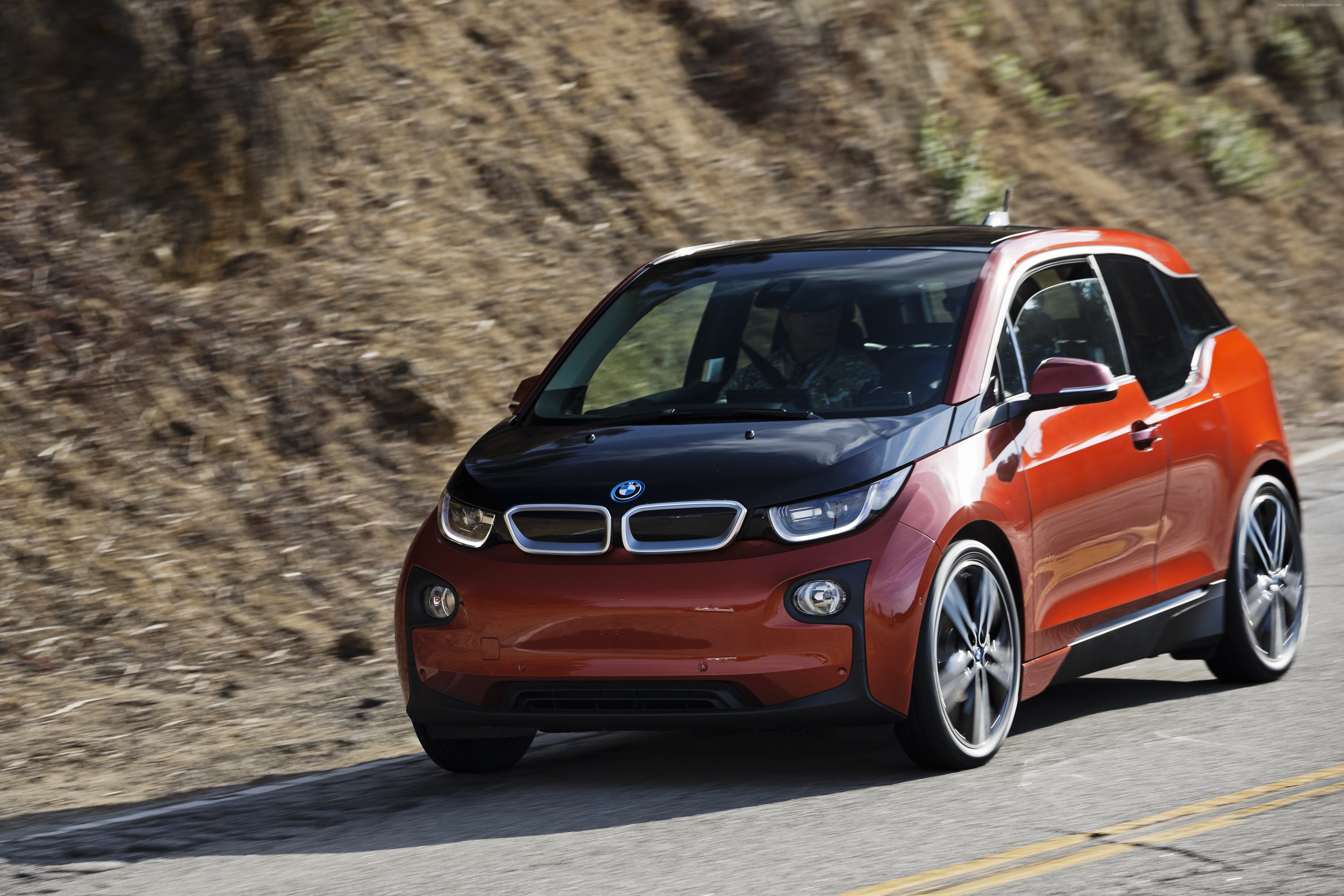 Orange BMW i3 REx driving on a road HD Wallpaper