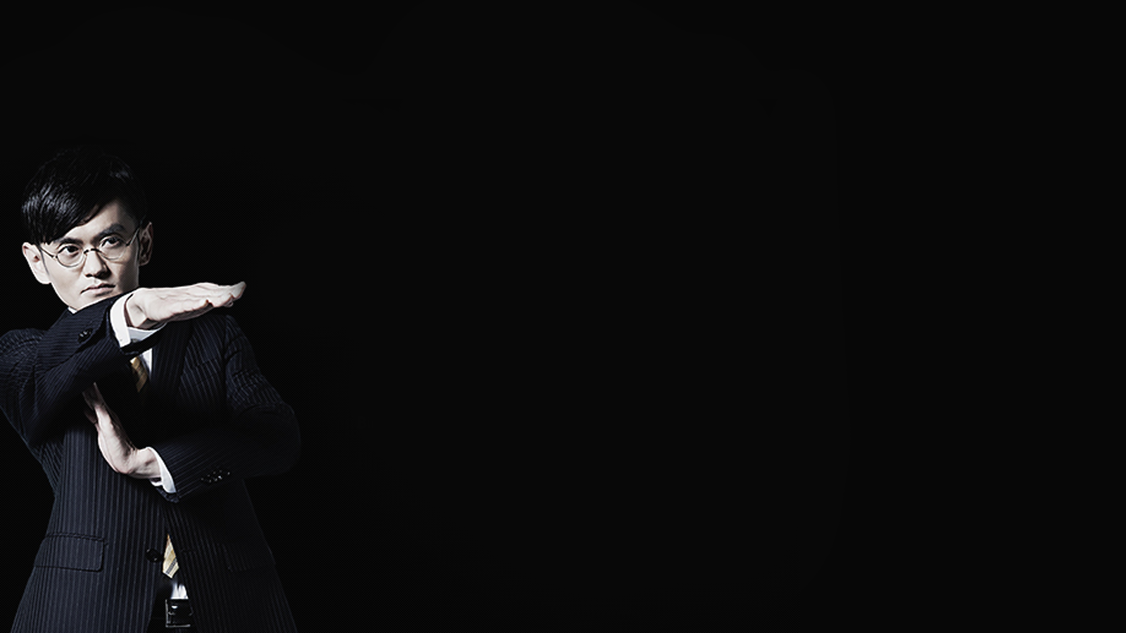 Genki Sudo in a suit making a 'T' sign HD Wallpaper