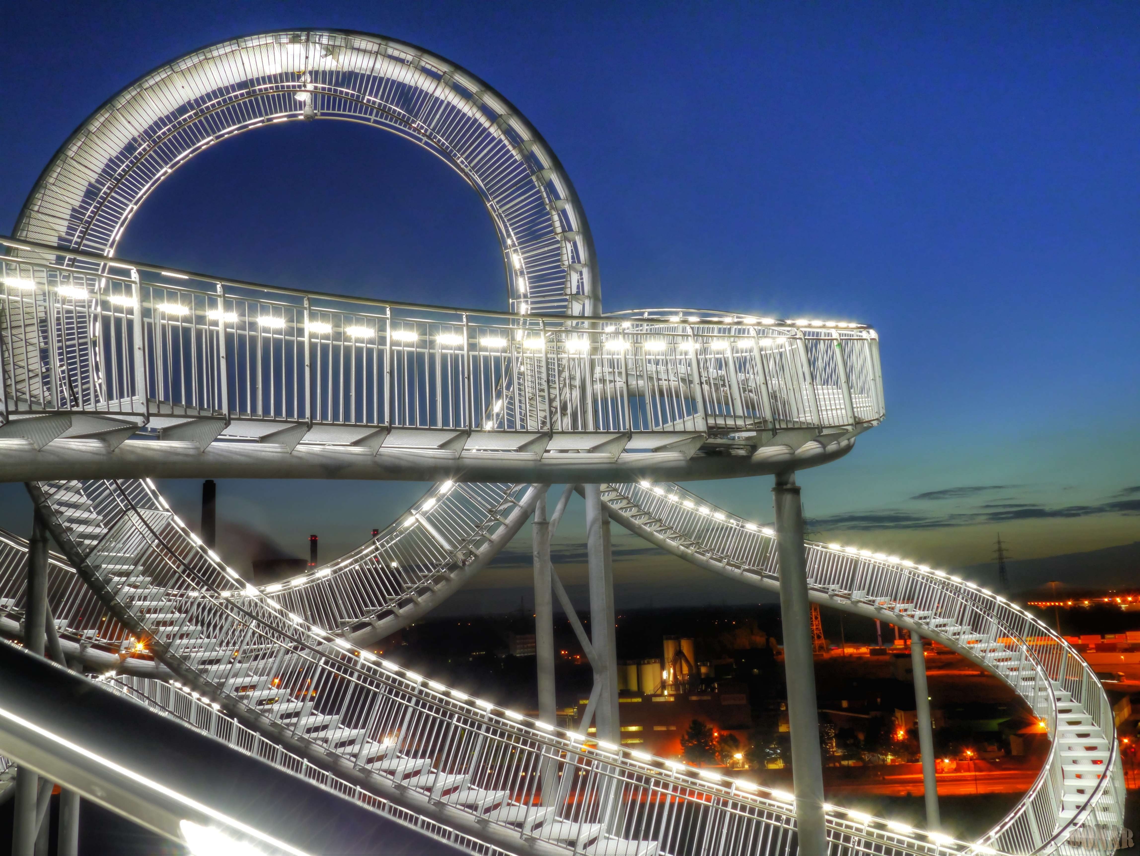 Tiger and Turtle Magic Mountain illuminated at night HD Wallpaper