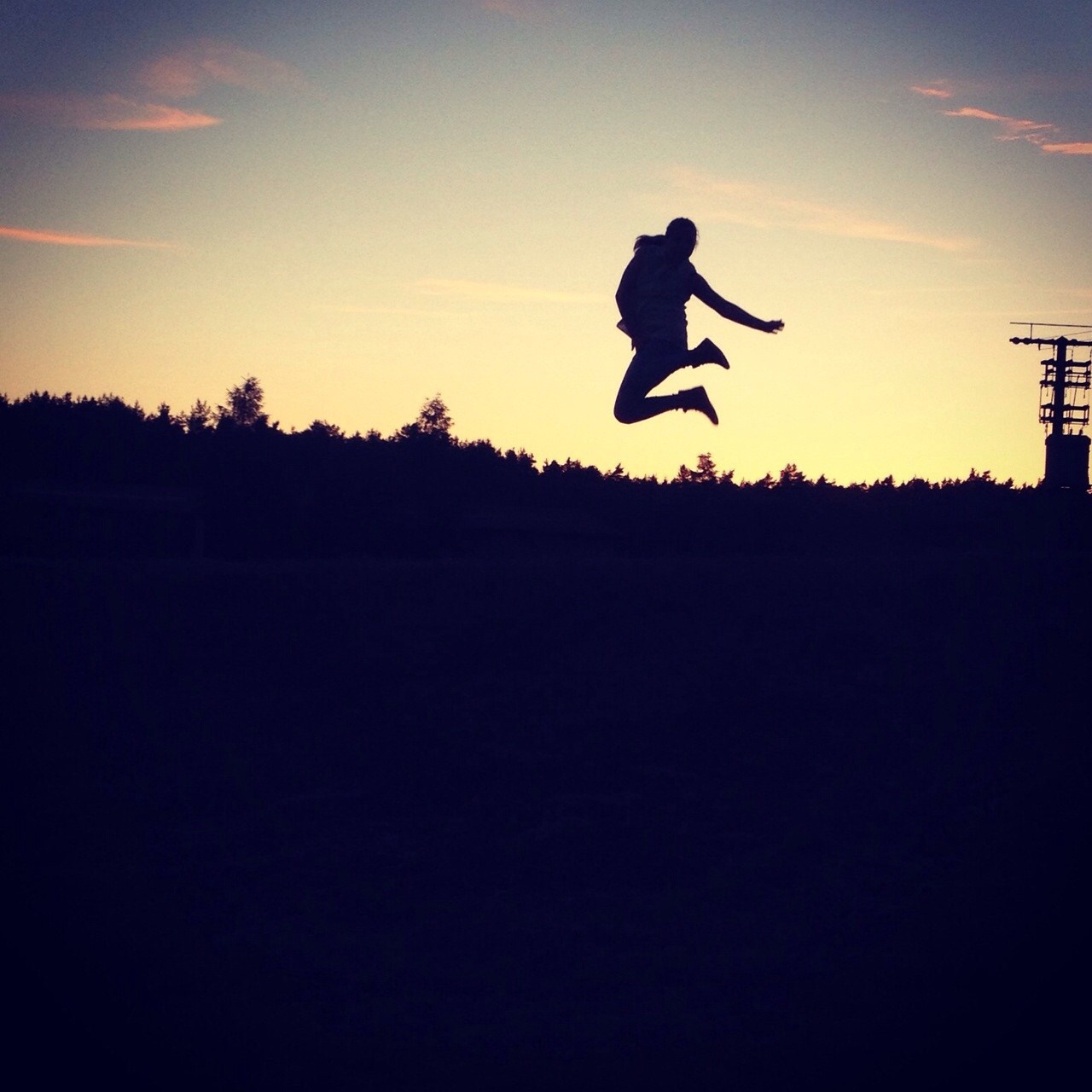 Silhouette of a person jumping at sunset HD Wallpaper