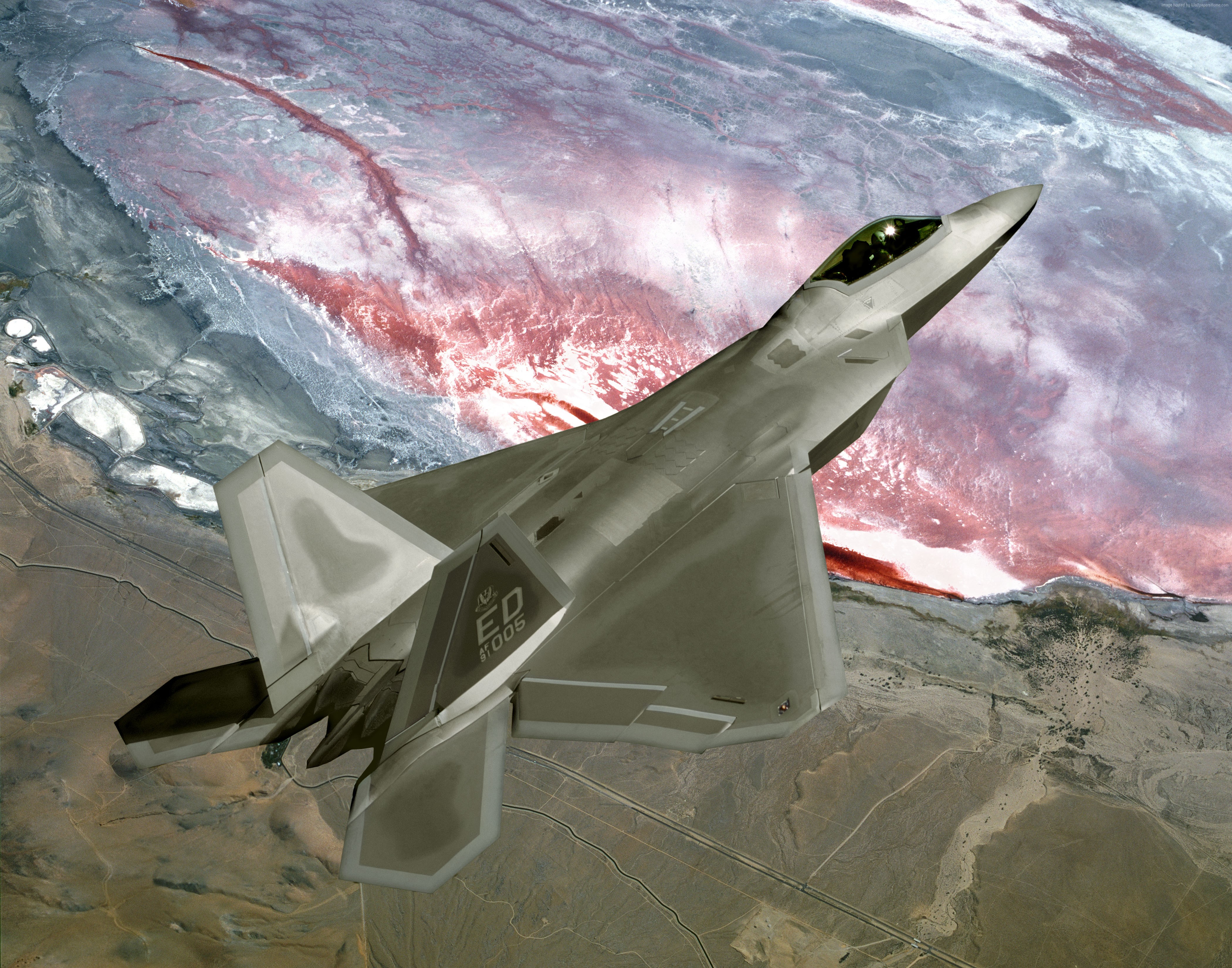 Lockheed Martin F-22 Raptor in flight over desert HD Wallpaper