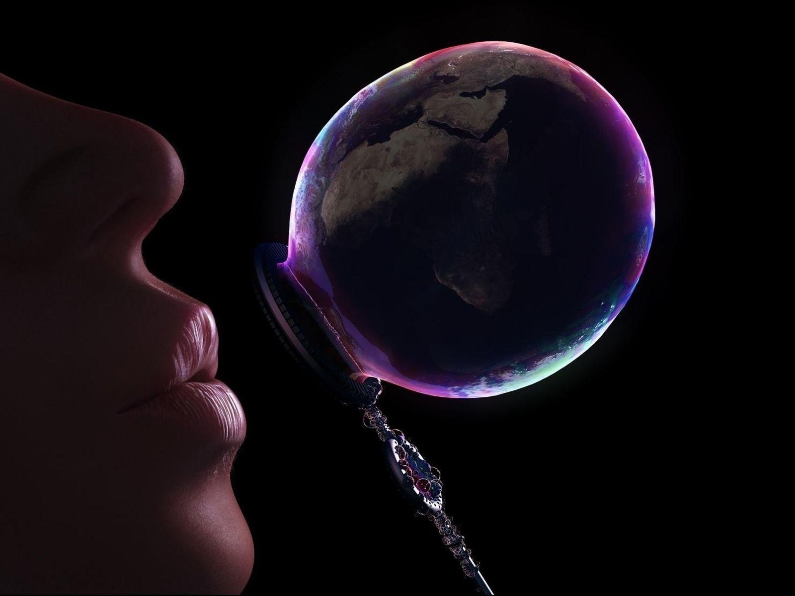 Person blowing a bubble shaped like Earth HD Wallpaper