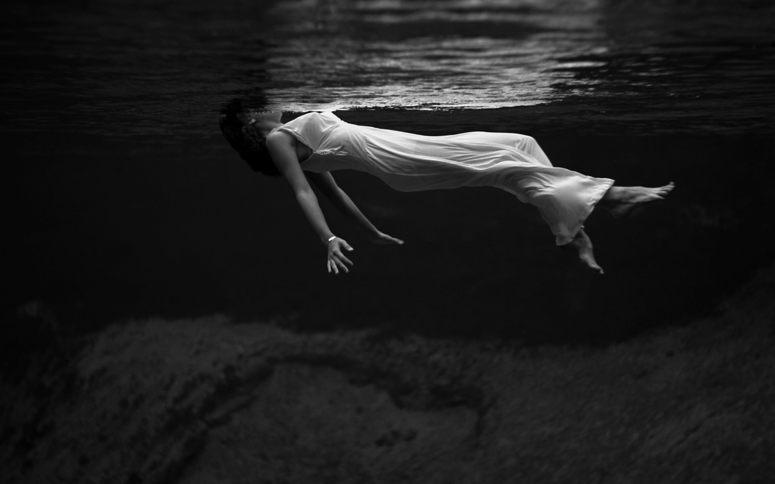 Monochrome underwater portrait of a woman in a white dress HD Wallpaper