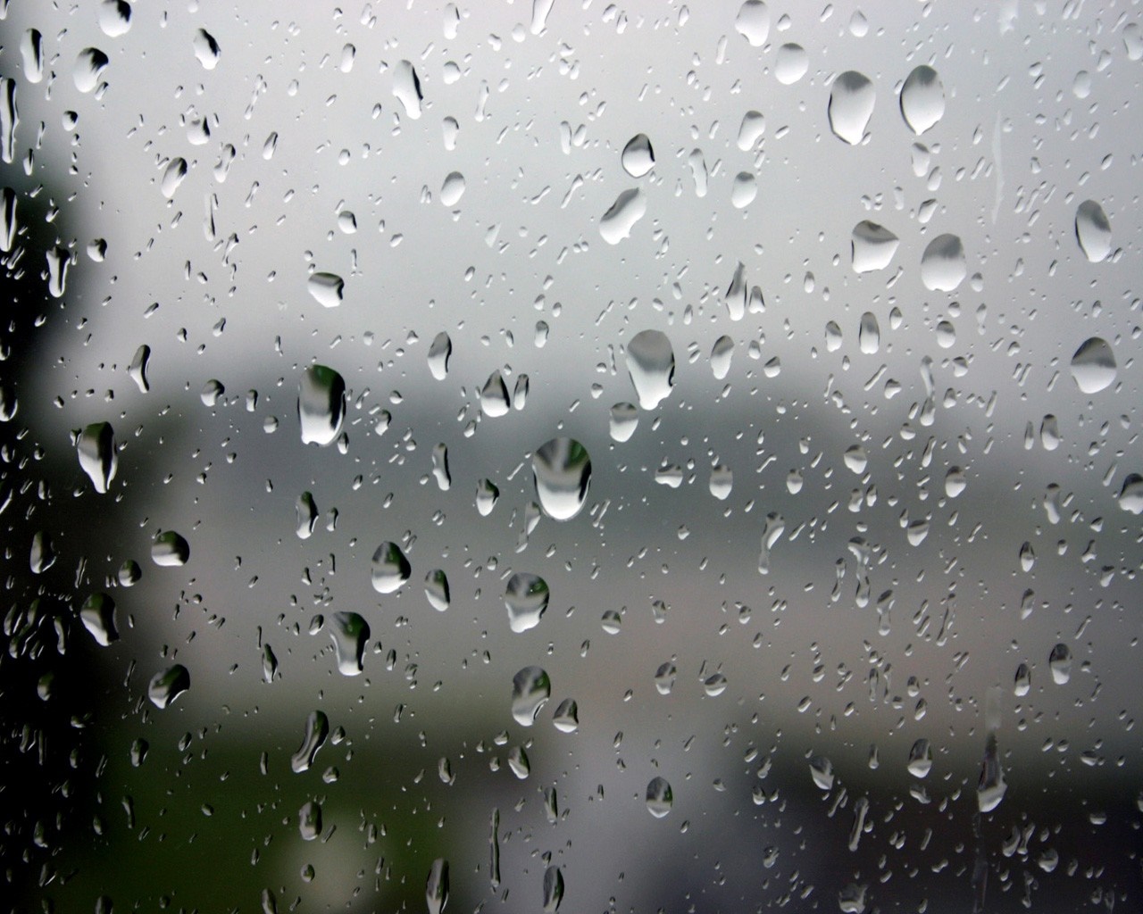 Raindrops on glass with blurred background HD Wallpaper