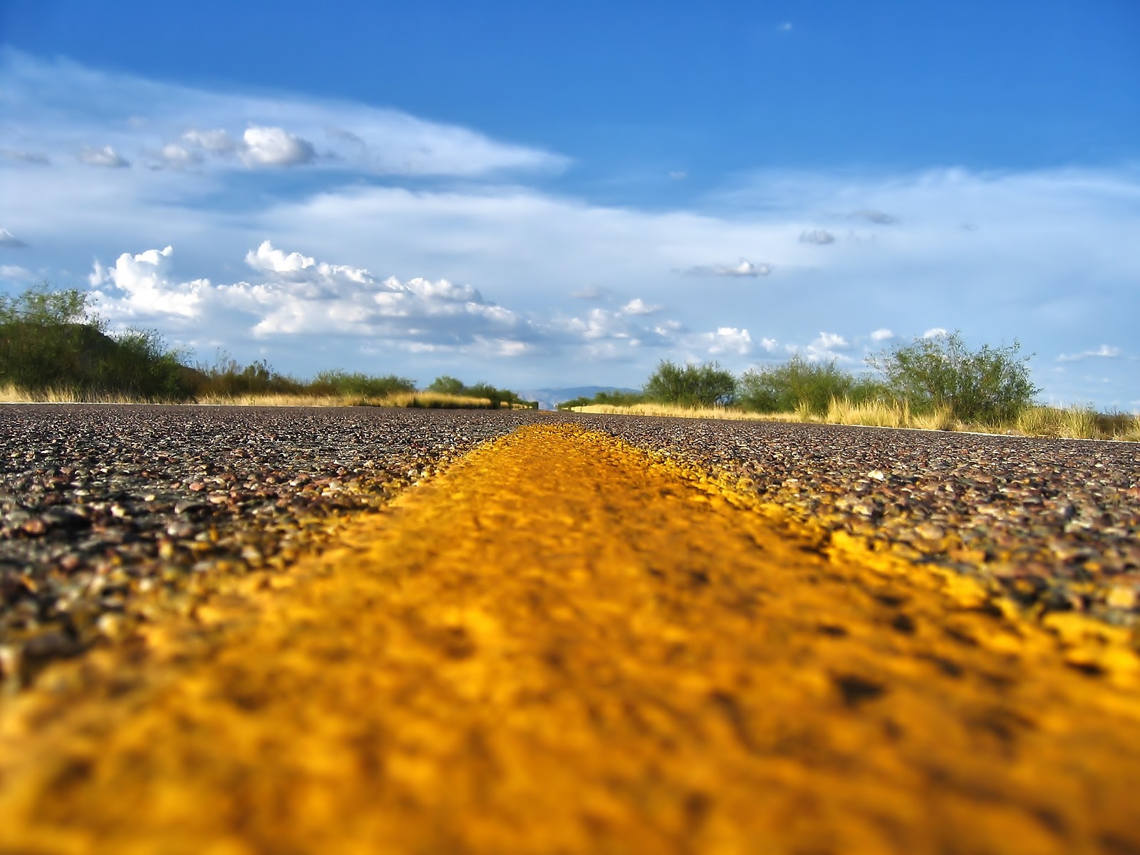 Road with yellow line and cloudy sky HD Wallpaper