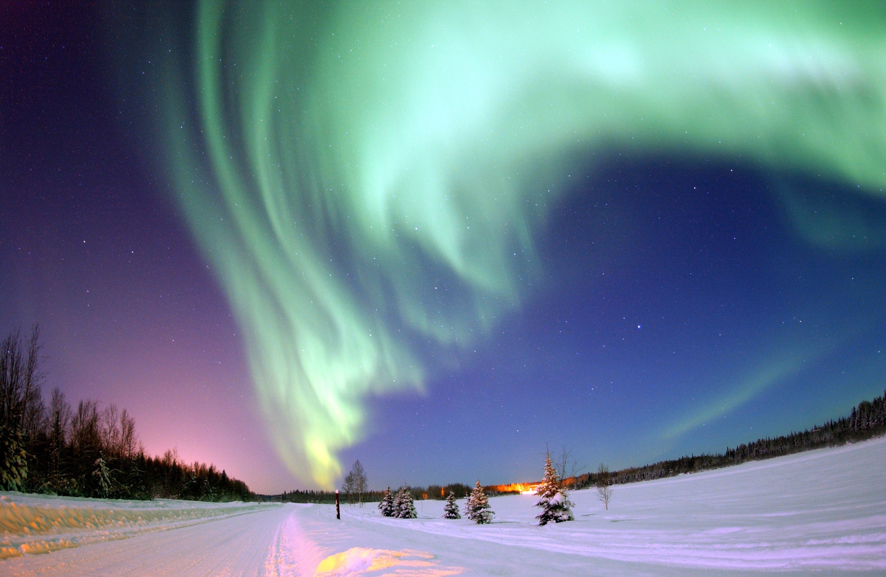 Aurora Borealis over a snowy landscape HD Wallpaper