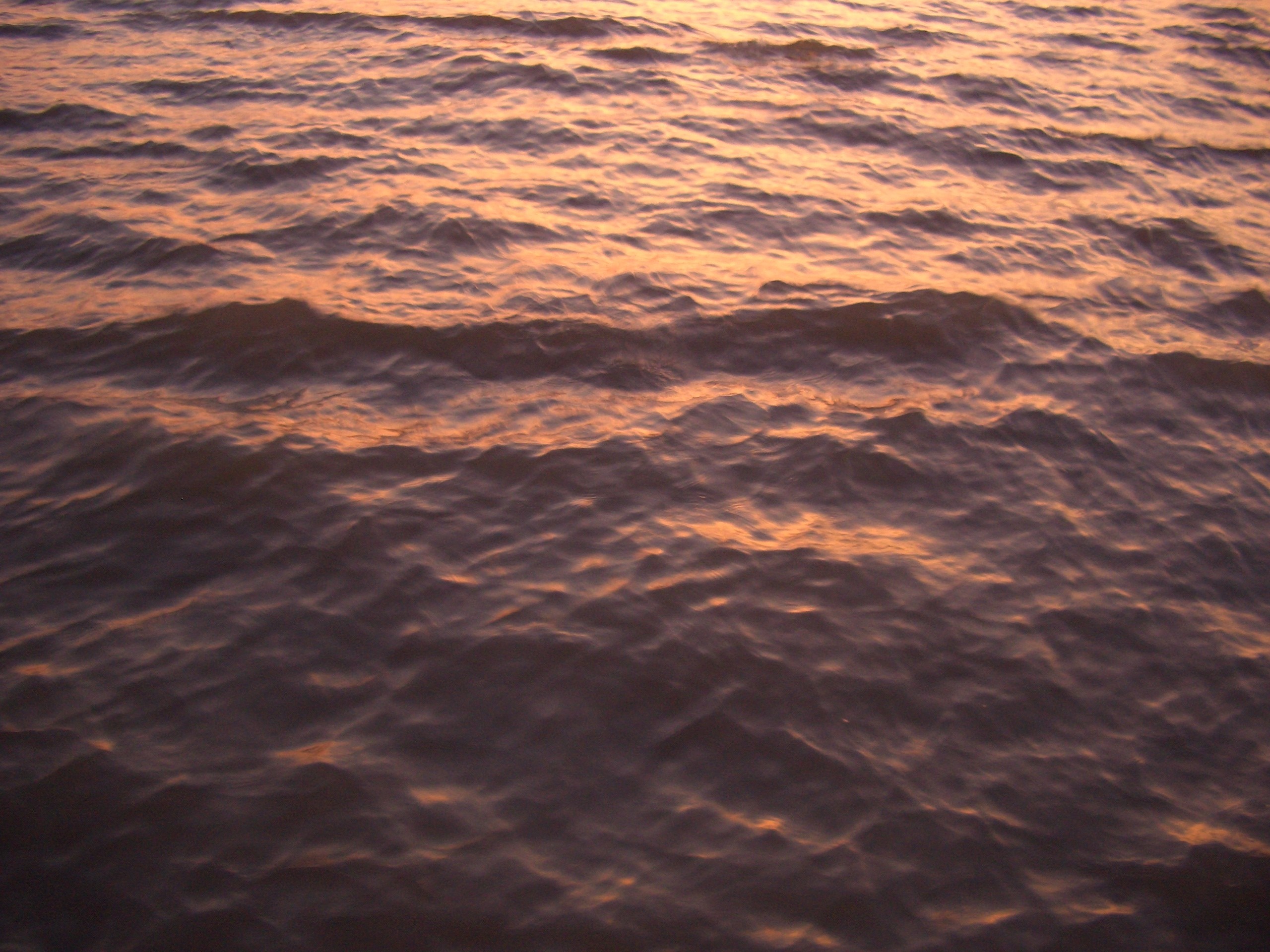 Sunset over rippling water HD Wallpaper