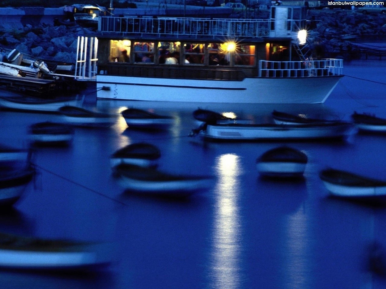 Boats docked at night in Istanbul with reflections HD Wallpaper