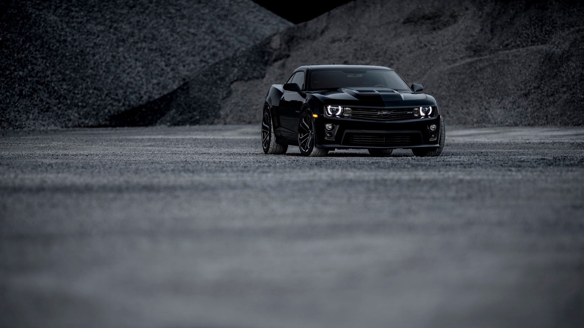 Black Chevrolet Camaro parked on gravel HD Wallpaper