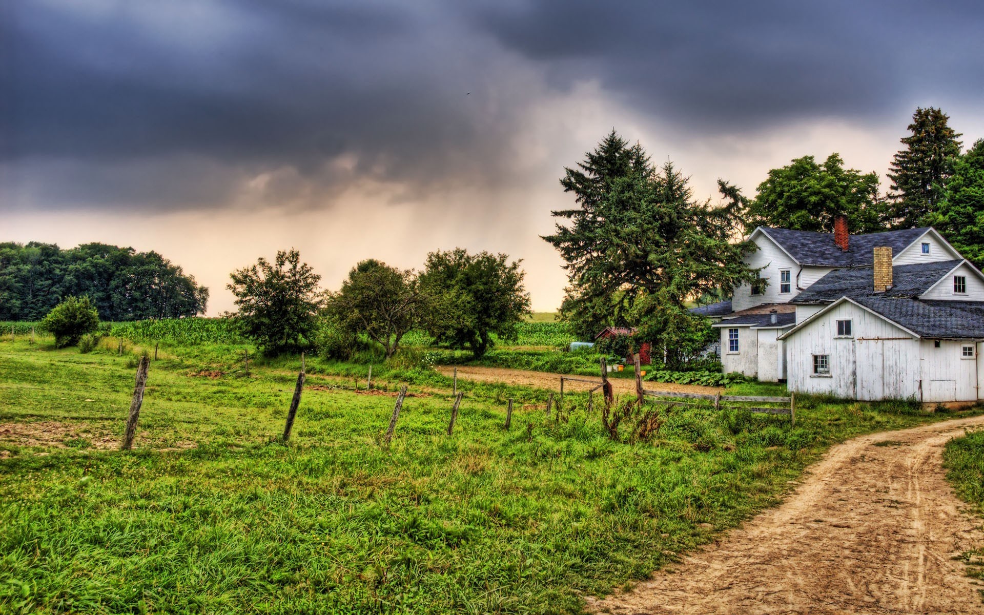 Farmhouse with dirt road and stormy sky HD Wallpaper