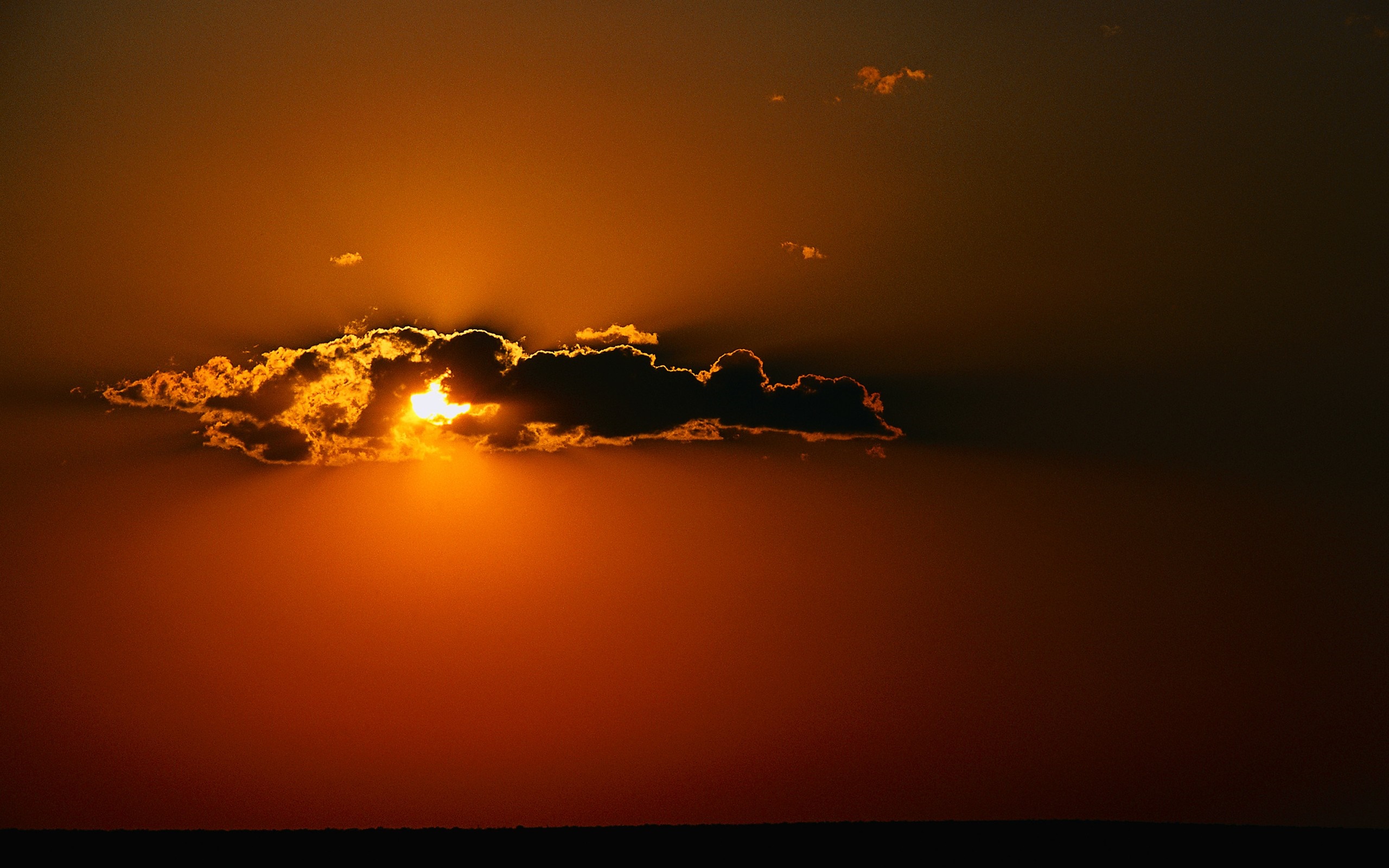 Sunset with sunbeams behind a cloud HD Wallpaper