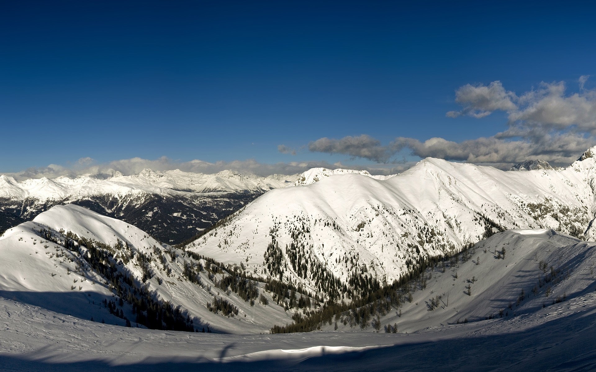 Snow-covered mountains under a clear blue sky HD Wallpaper