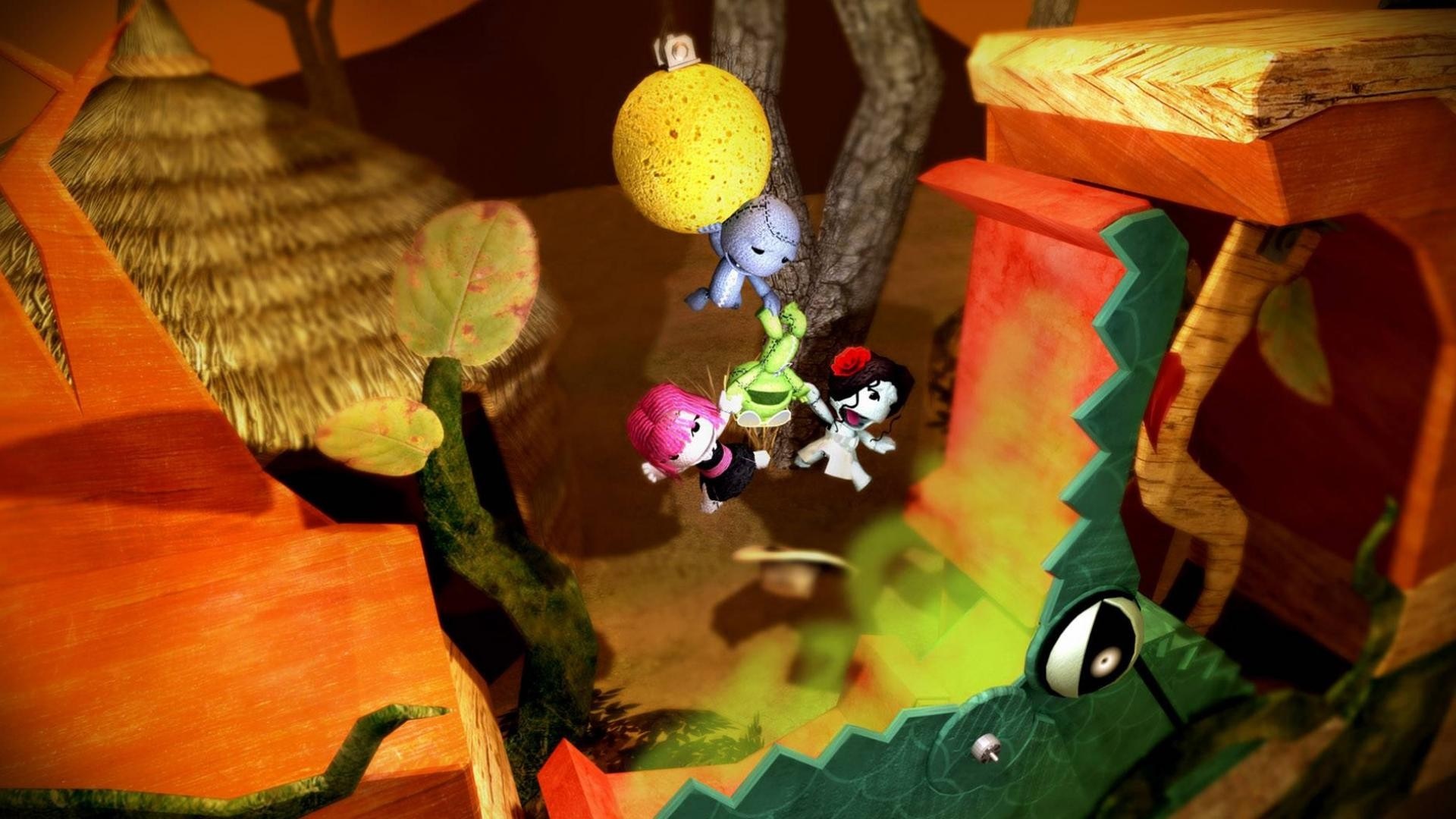 LittleBigPlanet characters hanging from a yellow ball HD Wallpaper