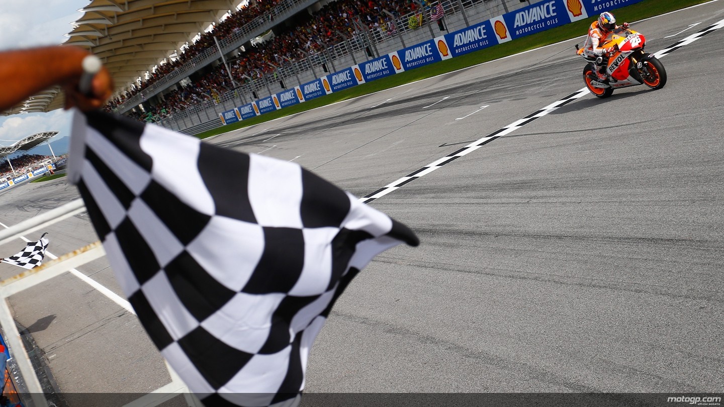 Motorcyclist crosses finish line with checkered flag HD Wallpaper