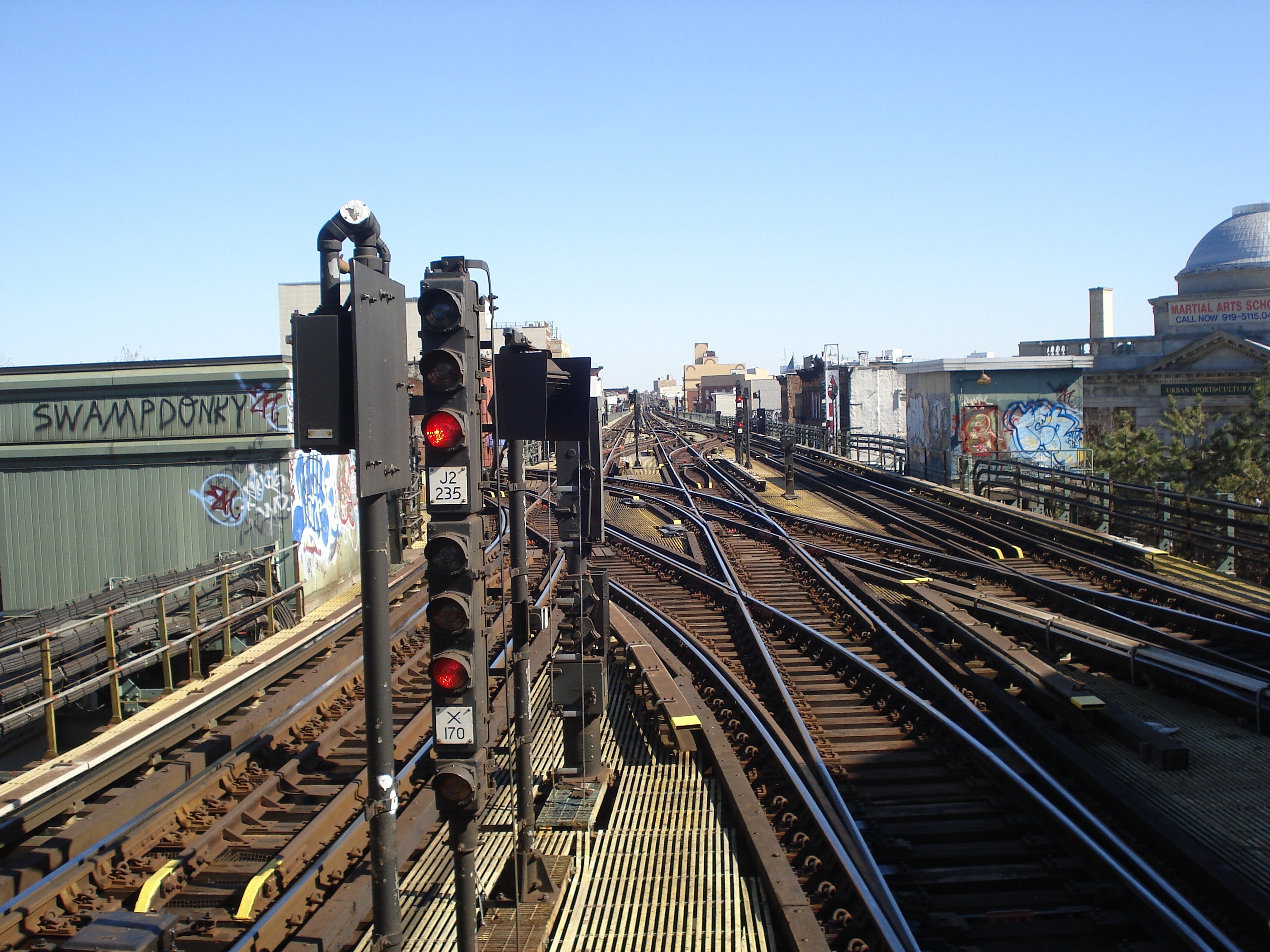 Elevated train tracks and signals in a city HD Wallpaper