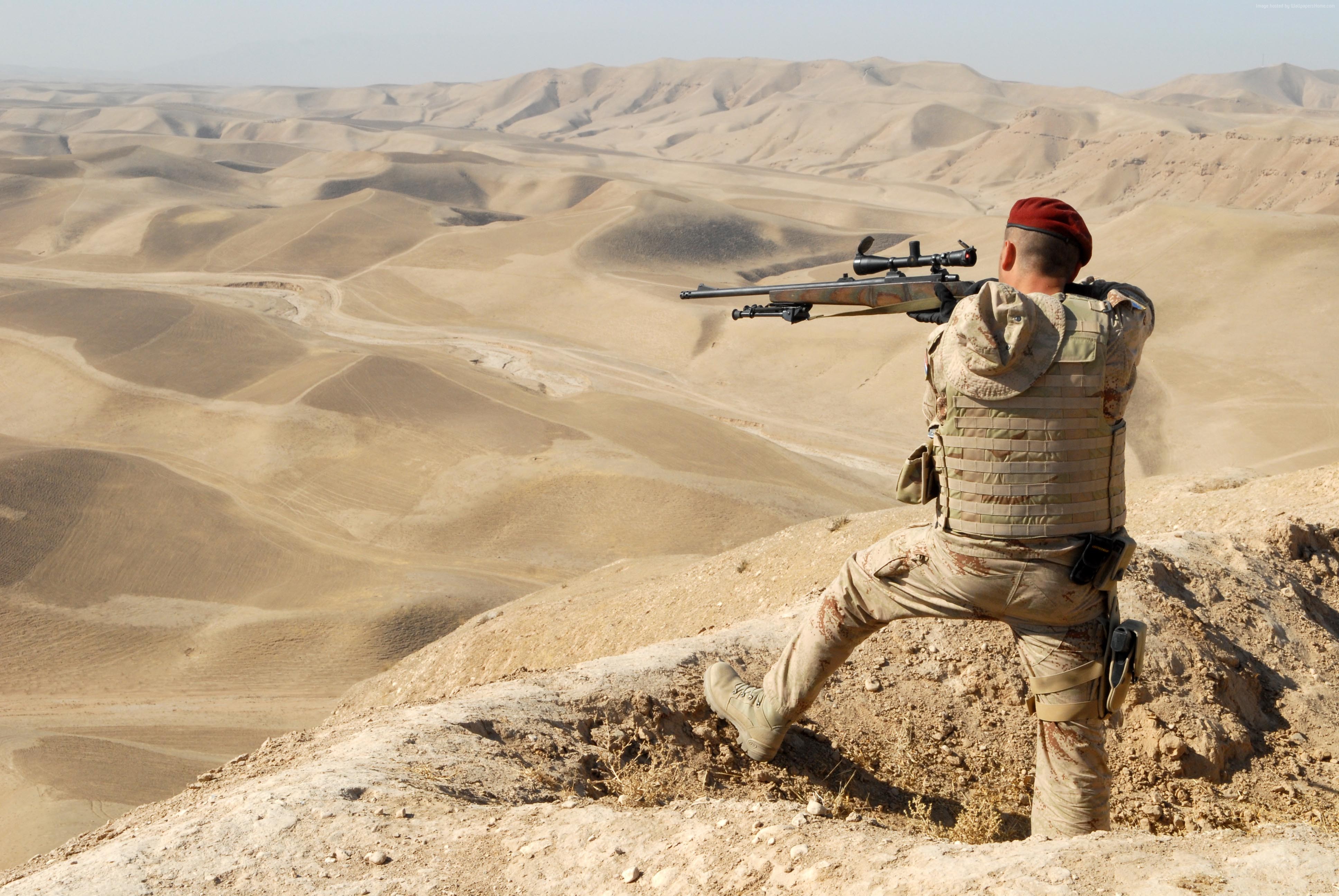 Soldier with sniper rifle in desert landscape HD Wallpaper