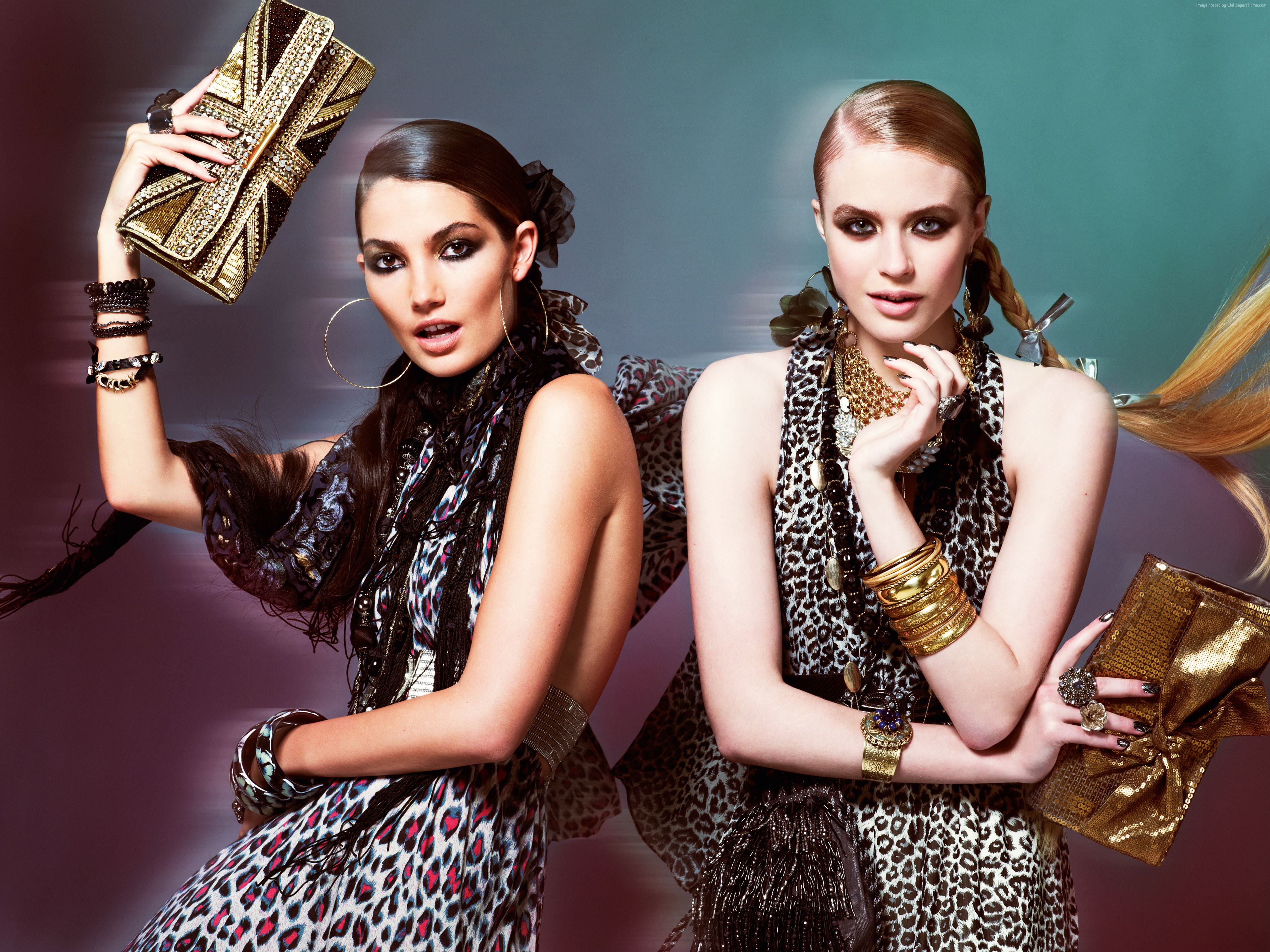 Two models in leopard print dresses with glamorous accessories HD Wallpaper