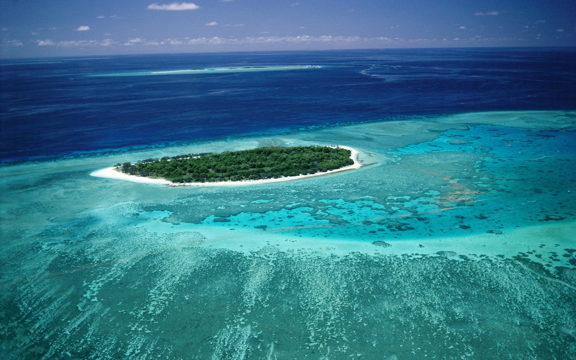 Island surrounded by coral reef and ocean HD Wallpaper