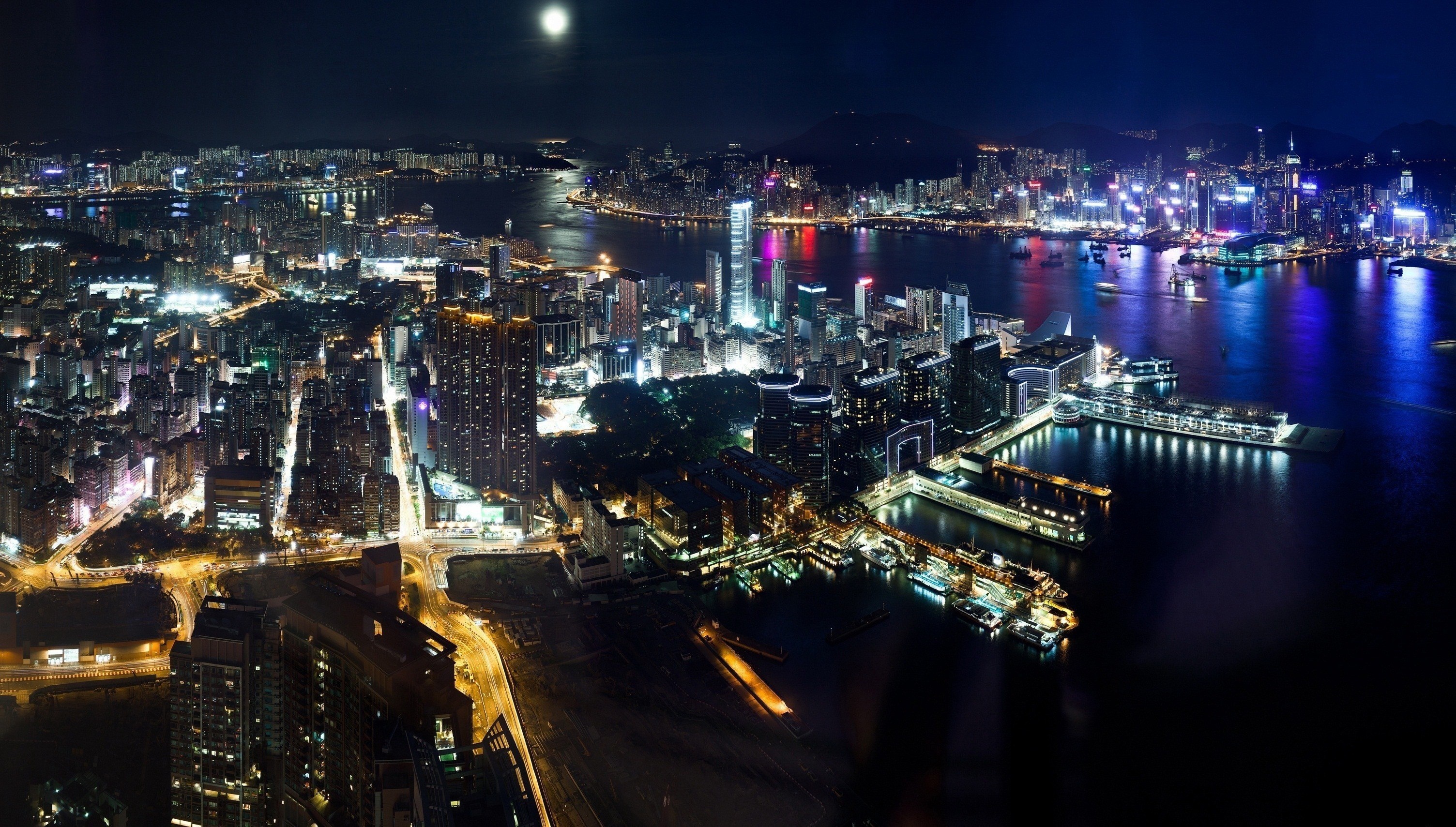 Night cityscape with illuminated skyscrapers and harbor HD Wallpaper