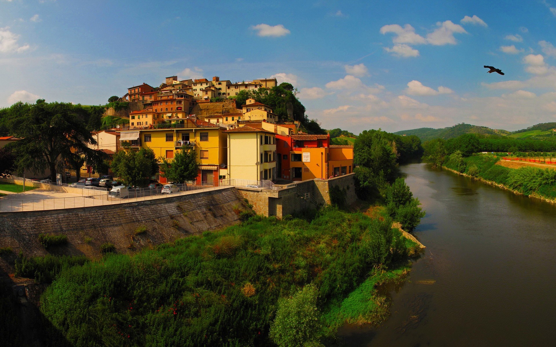 Town on a hill overlooking a river HD Wallpaper