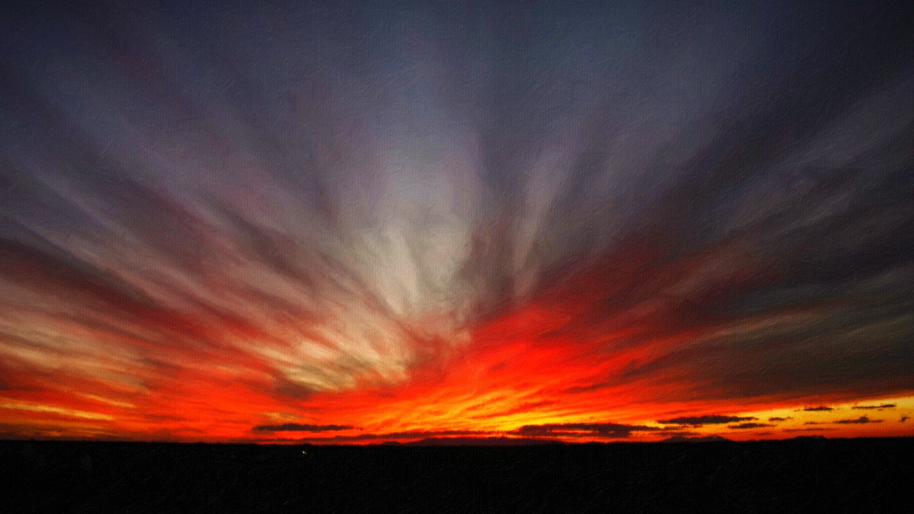 Dramatic sunset with fiery red and purple clouds over a dark horizon HD Wallpaper