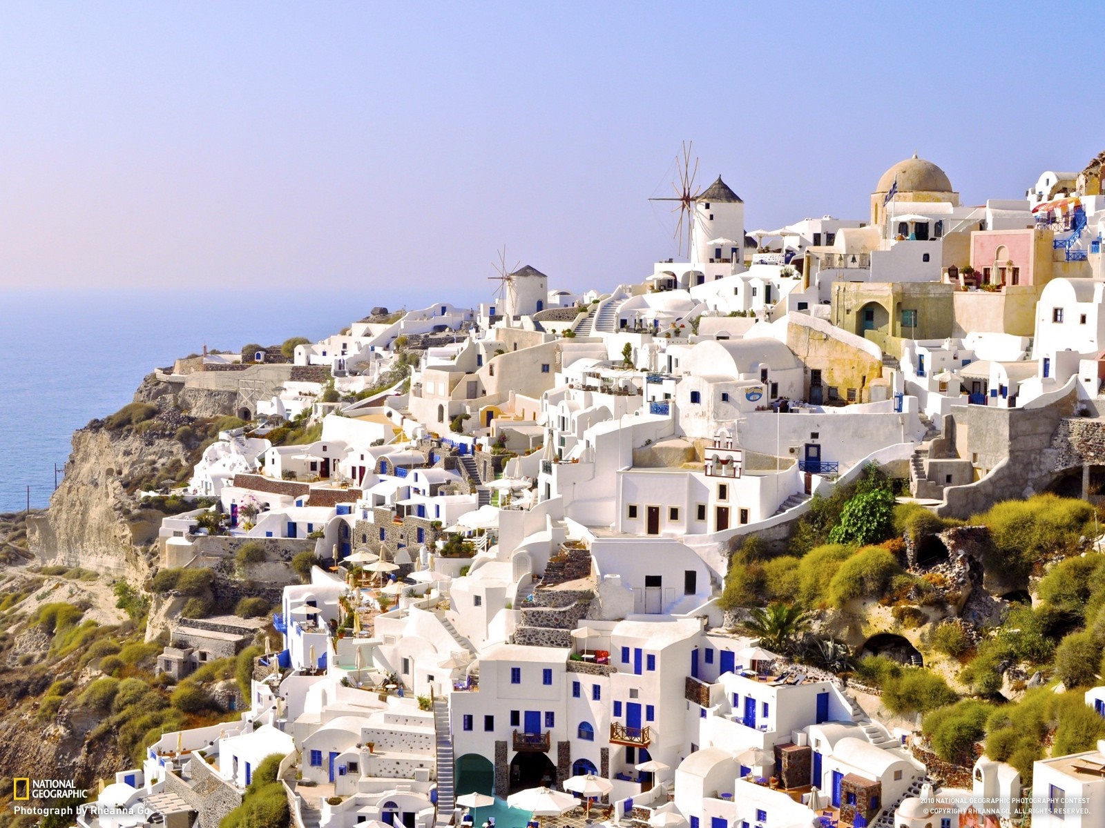 White village on a cliff overlooking the sea in Greece HD Wallpaper