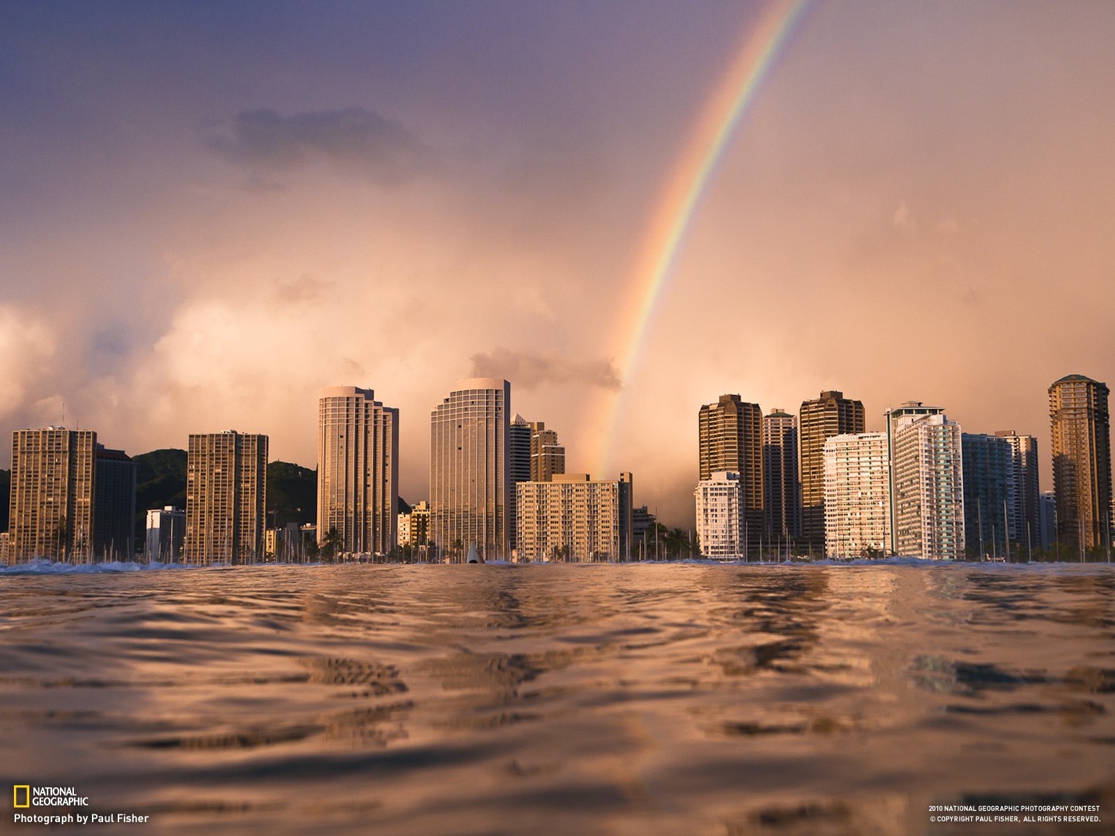 City skyline with rainbow over water HD Wallpaper