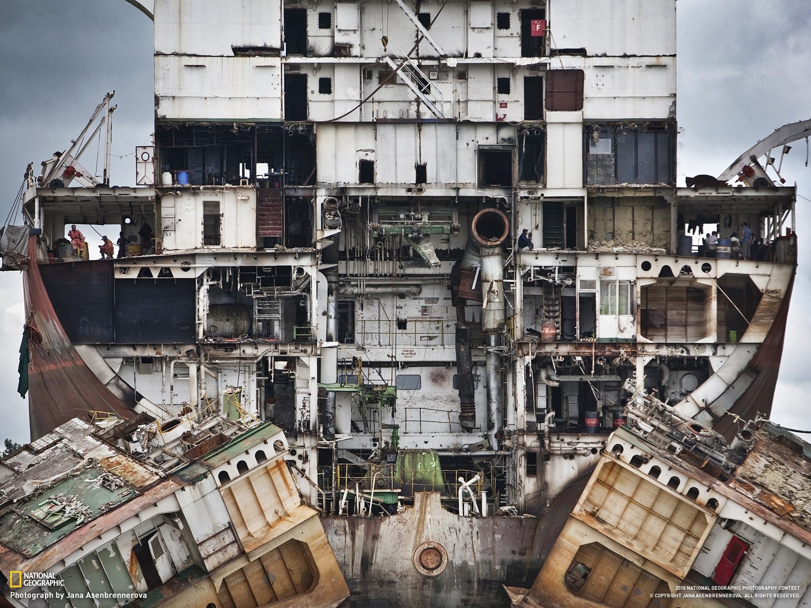 Shipwrecked vessel being dismantled HD Wallpaper