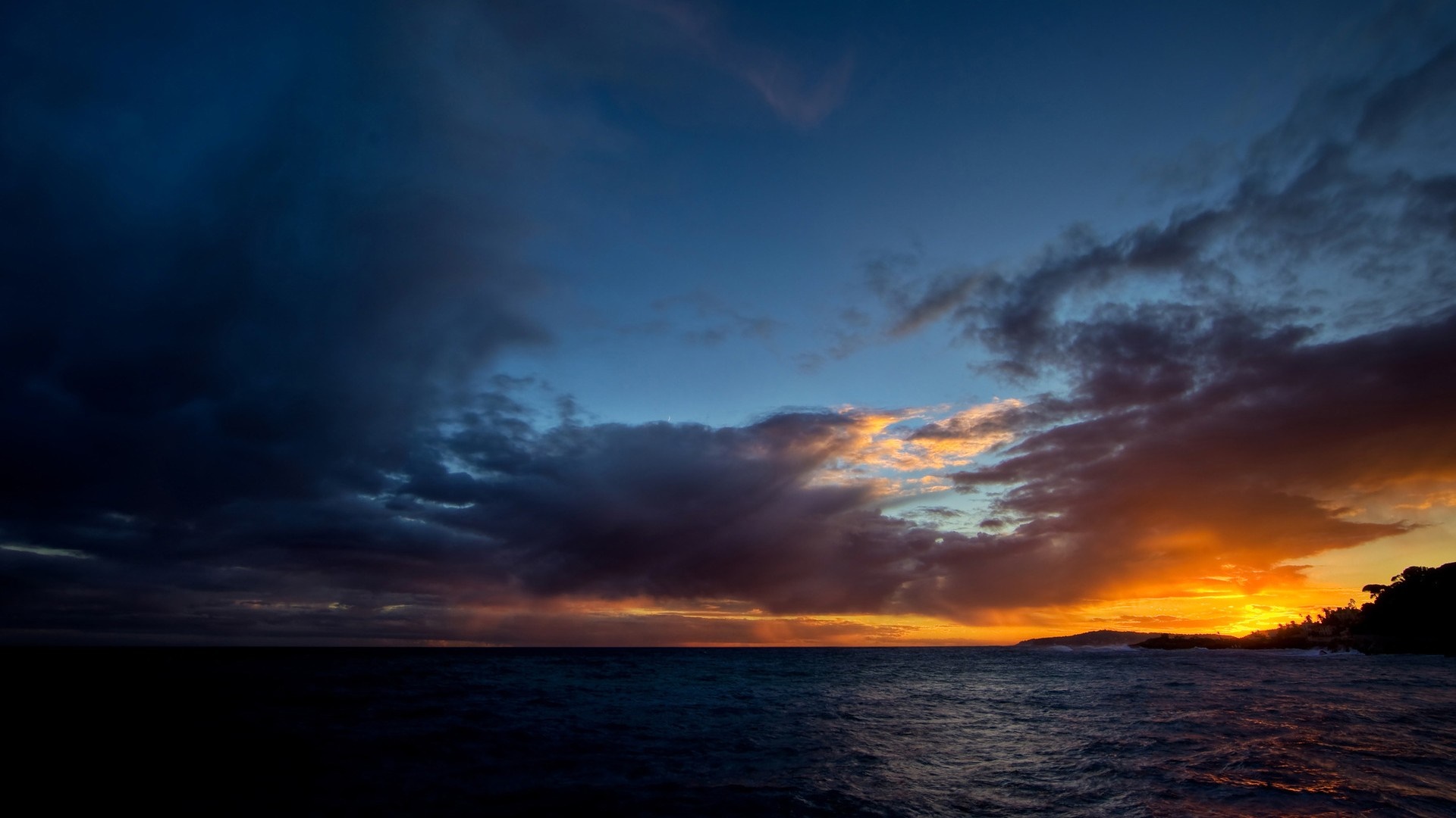 Sunset over the ocean with dramatic clouds HD Wallpaper