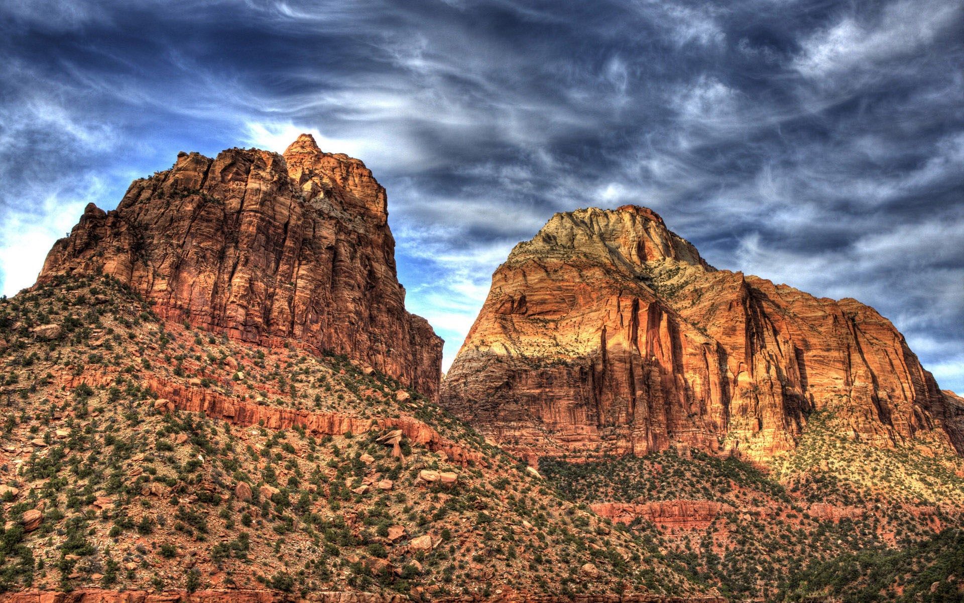 Two large sandstone mountains under a cloudy sky HD Wallpaper