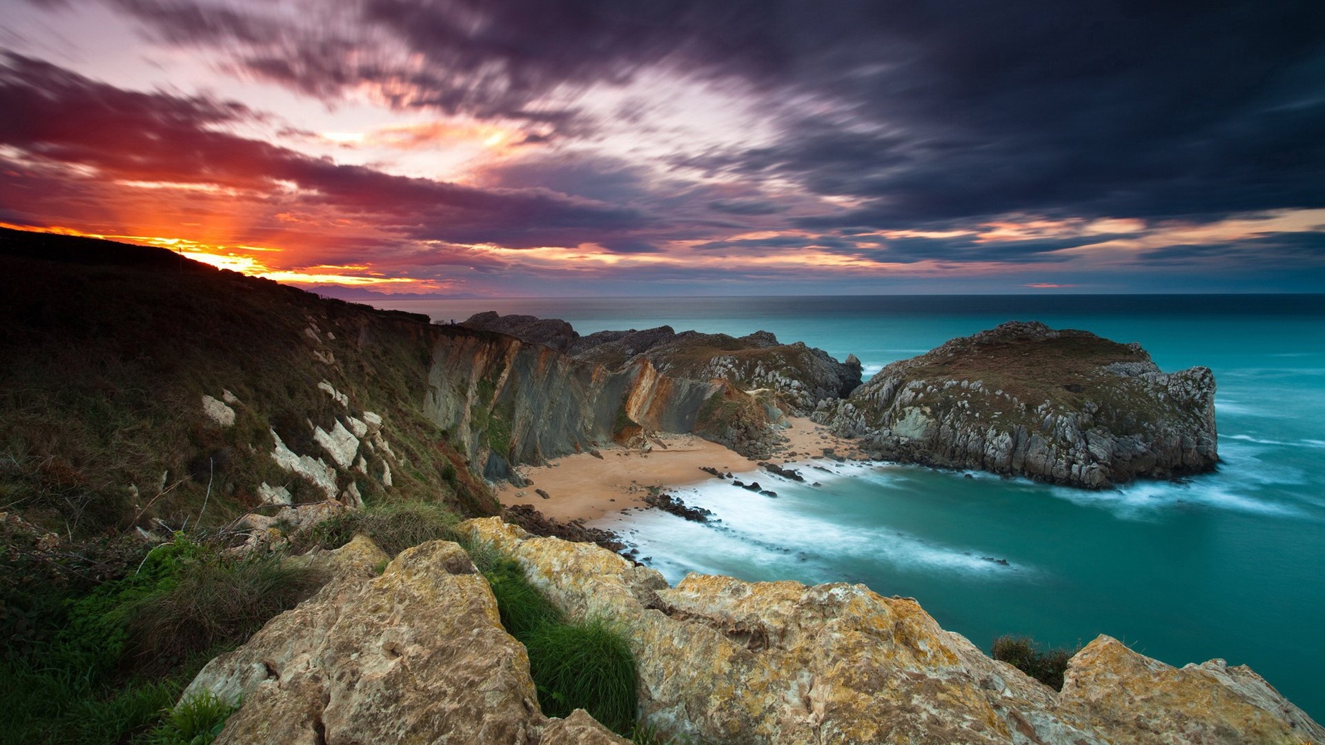 Sunset over a rocky coastline and bay HD Wallpaper