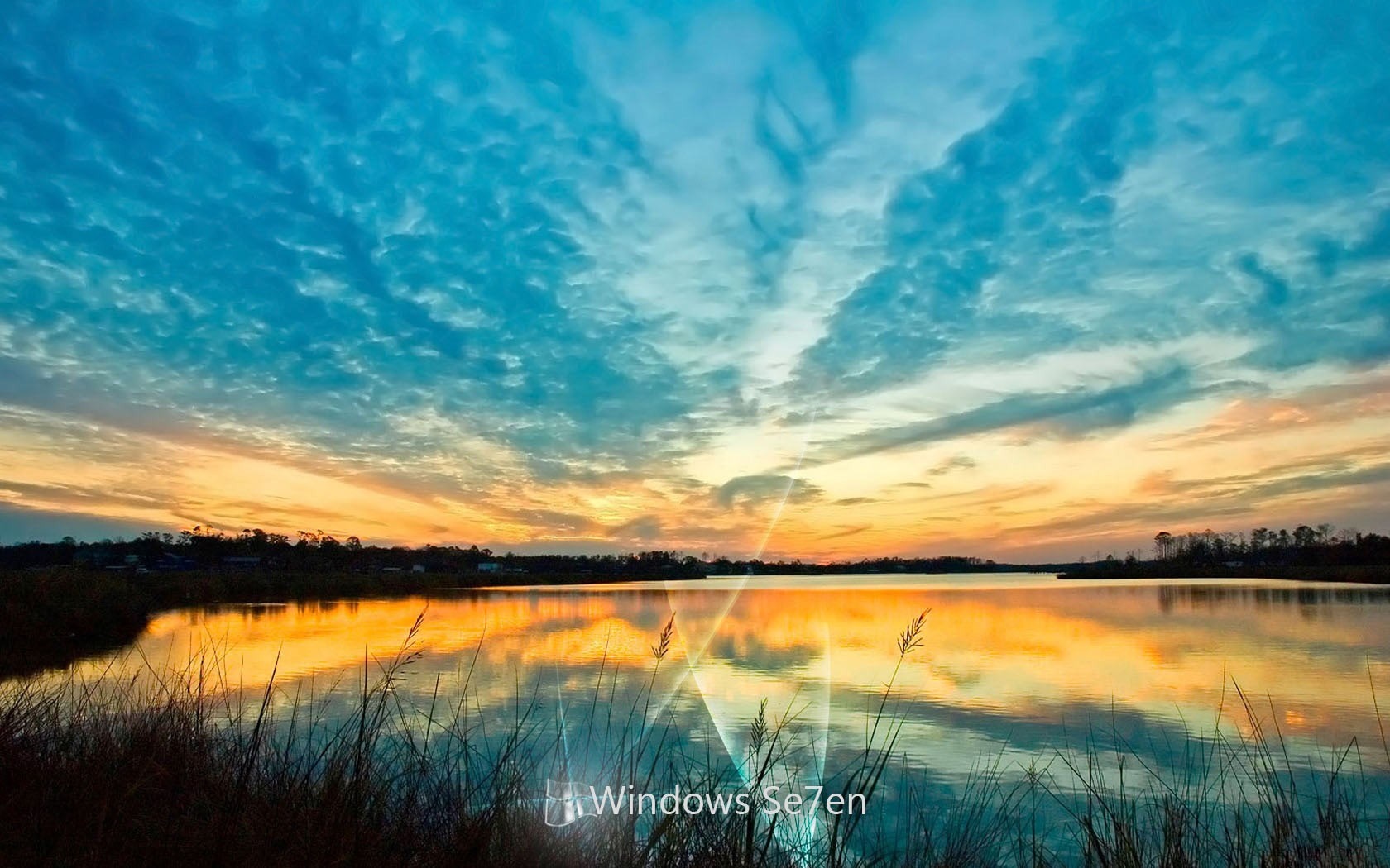 Sunset over a lake with reflections and clouds HD Wallpaper