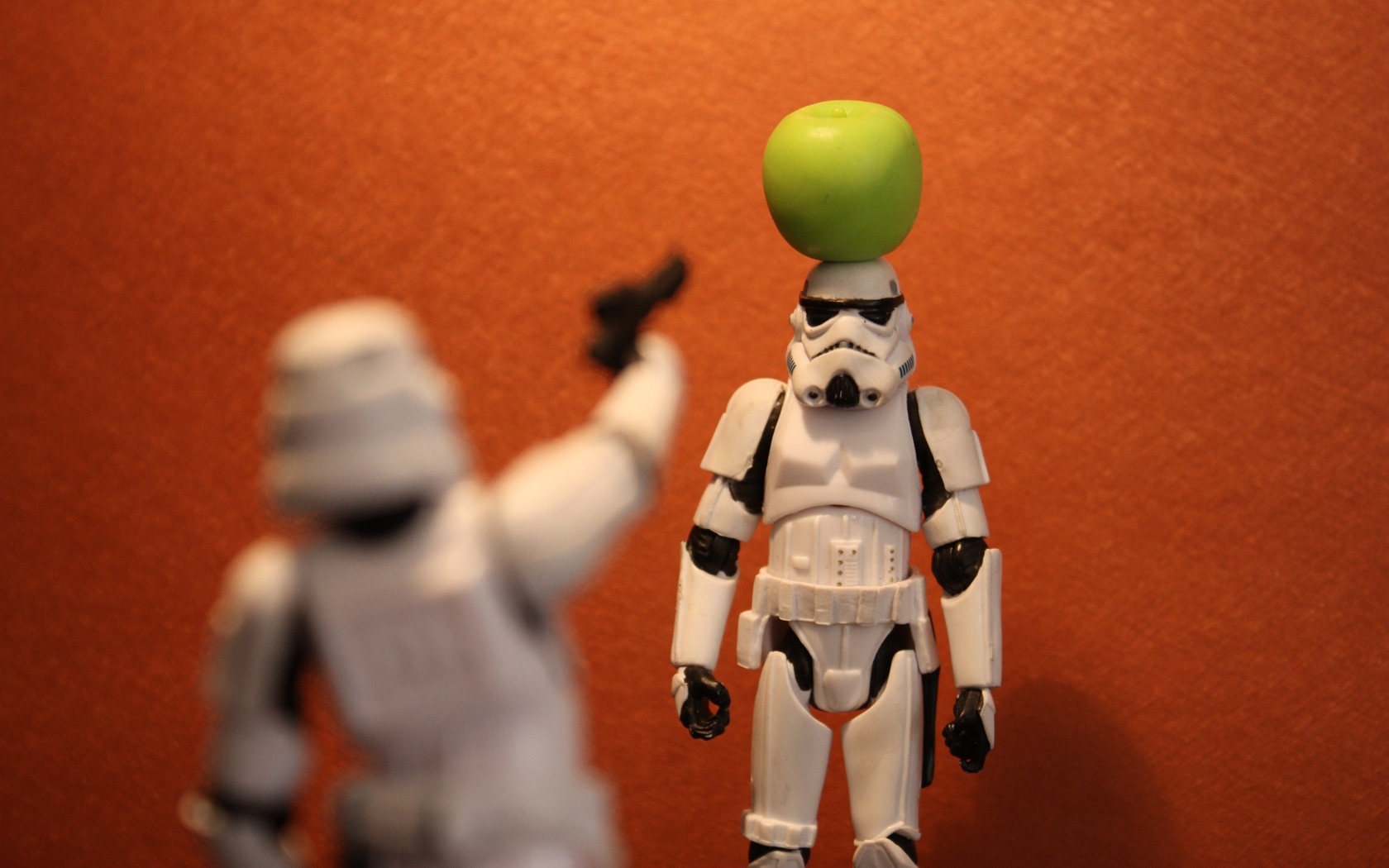 Stormtrooper action figures with an apple on head HD Wallpaper