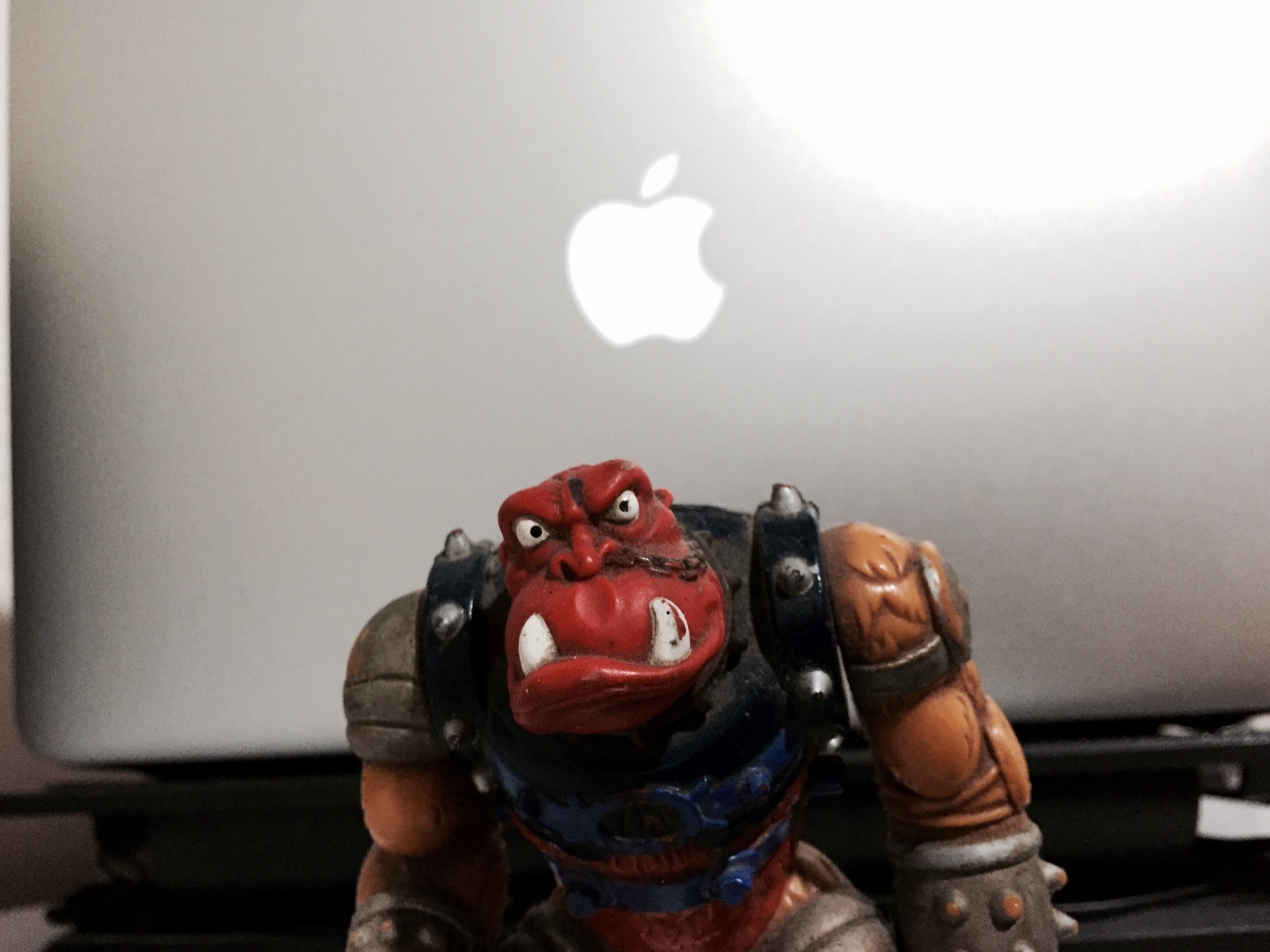 Red Orc Action Figure in front of Apple Laptop HD Wallpaper