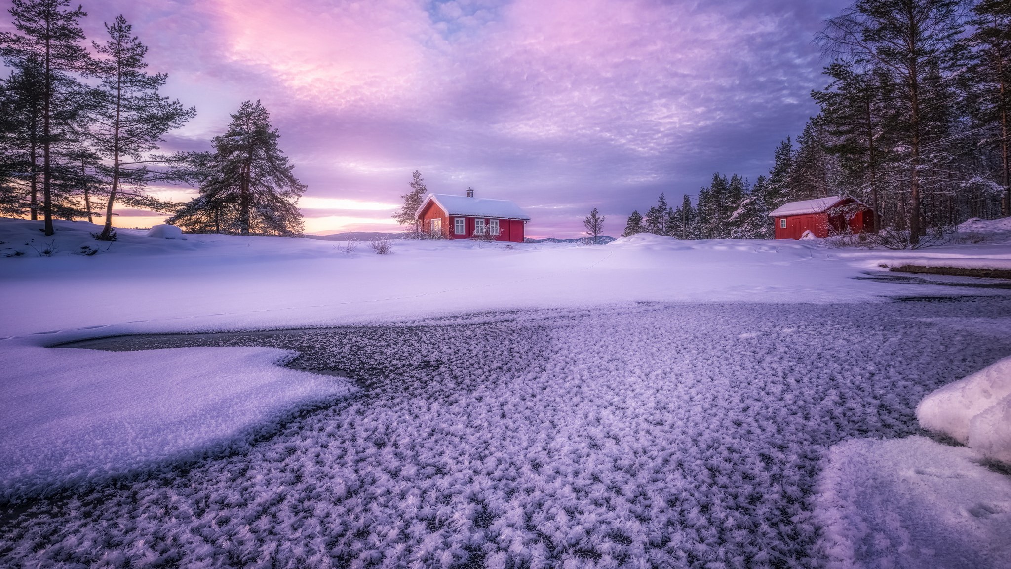 Red cabins in a snowy landscape at sunset HD Wallpaper