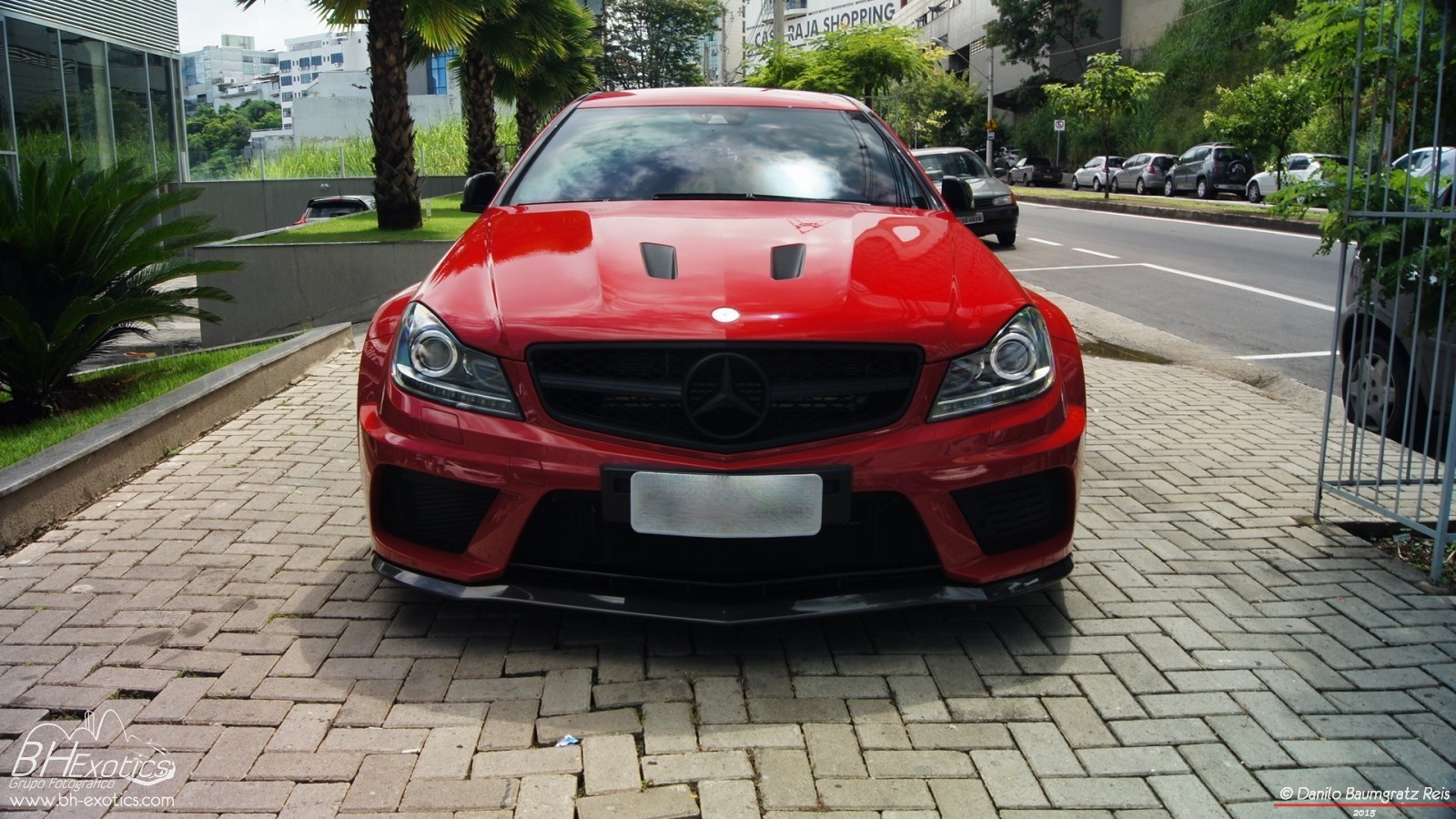 Red Mercedes Benz C63 AMG parked on brick driveway HD Wallpaper