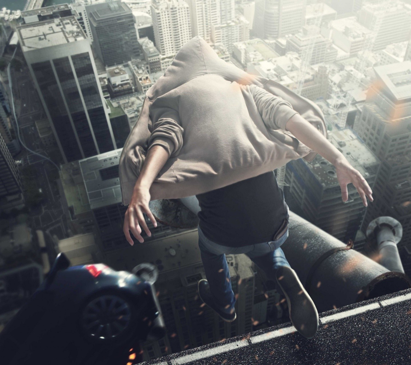 Man in hoodie jumping off a skyscraper HD Wallpaper