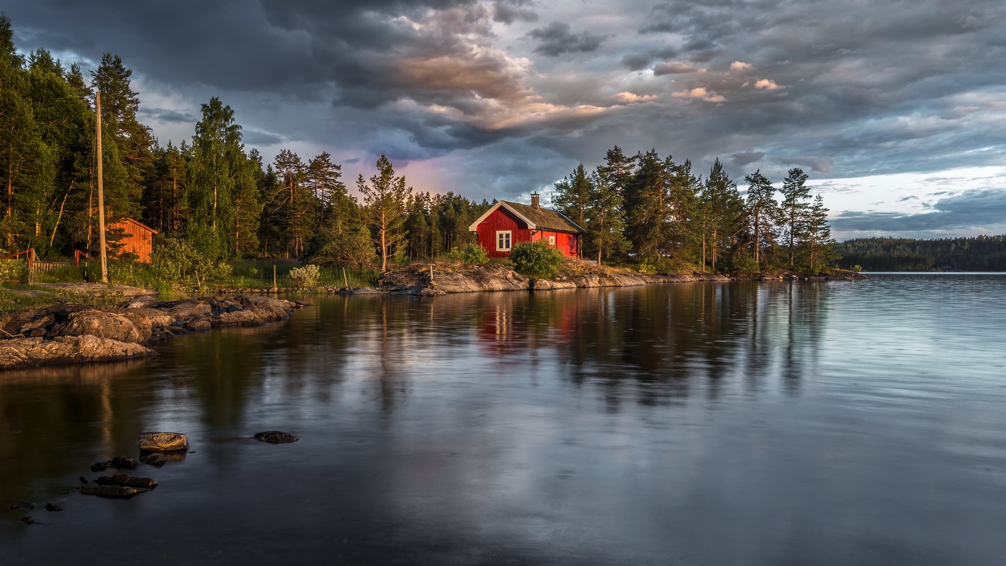 Red house by a lake with stormy clouds HD Wallpaper