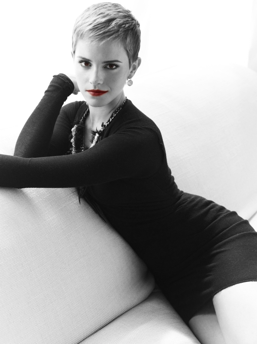 Emma Watson posing on a couch HD Wallpaper