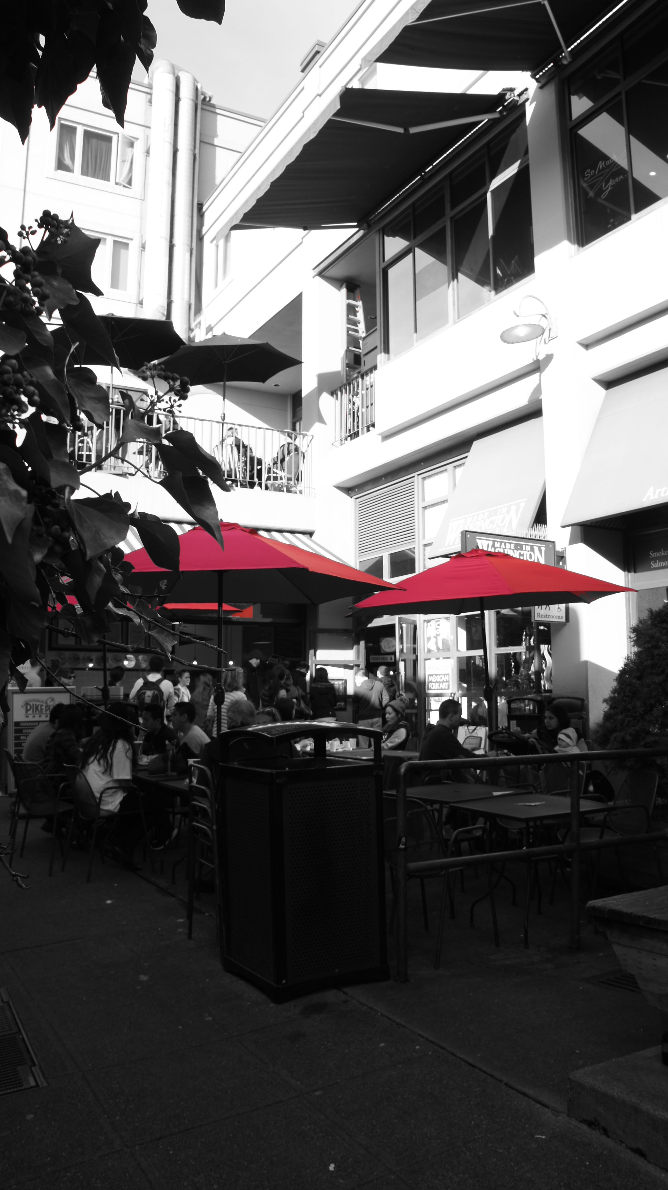Outdoor cafe with red umbrellas and people HD Wallpaper