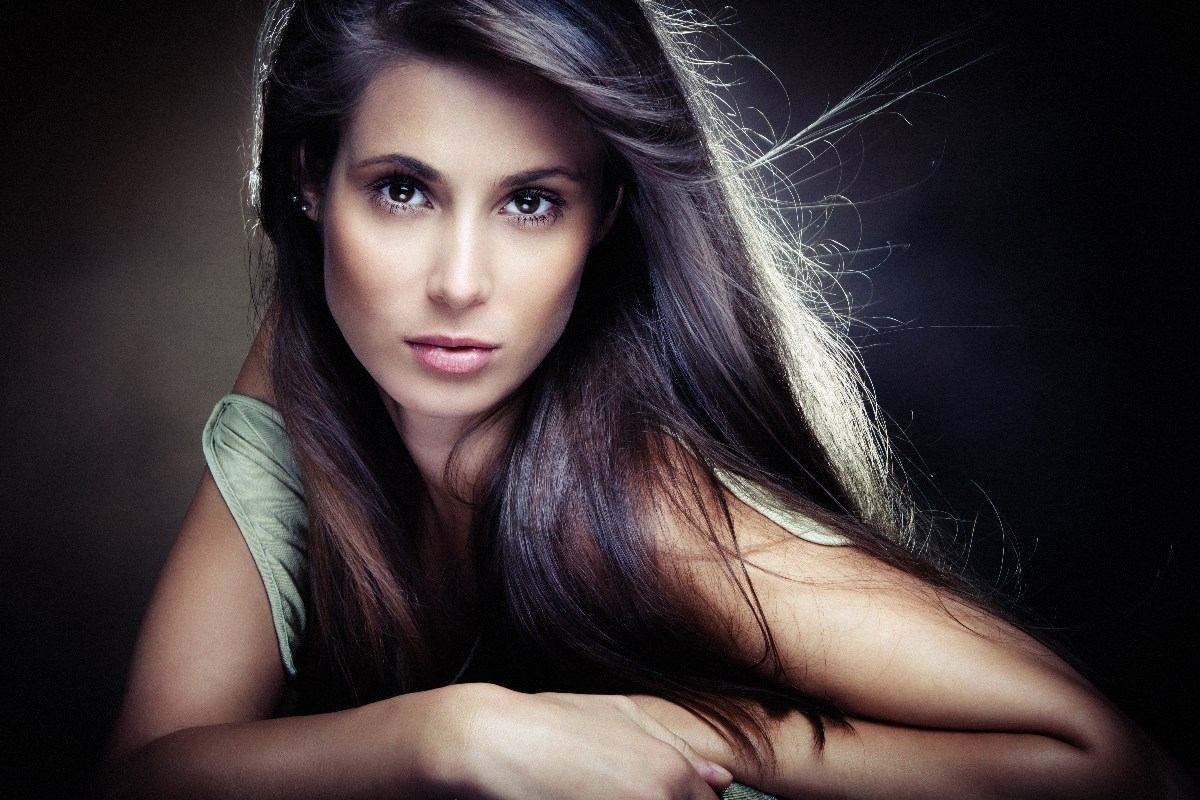 Woman with long brown hair in a studio portrait HD Wallpaper